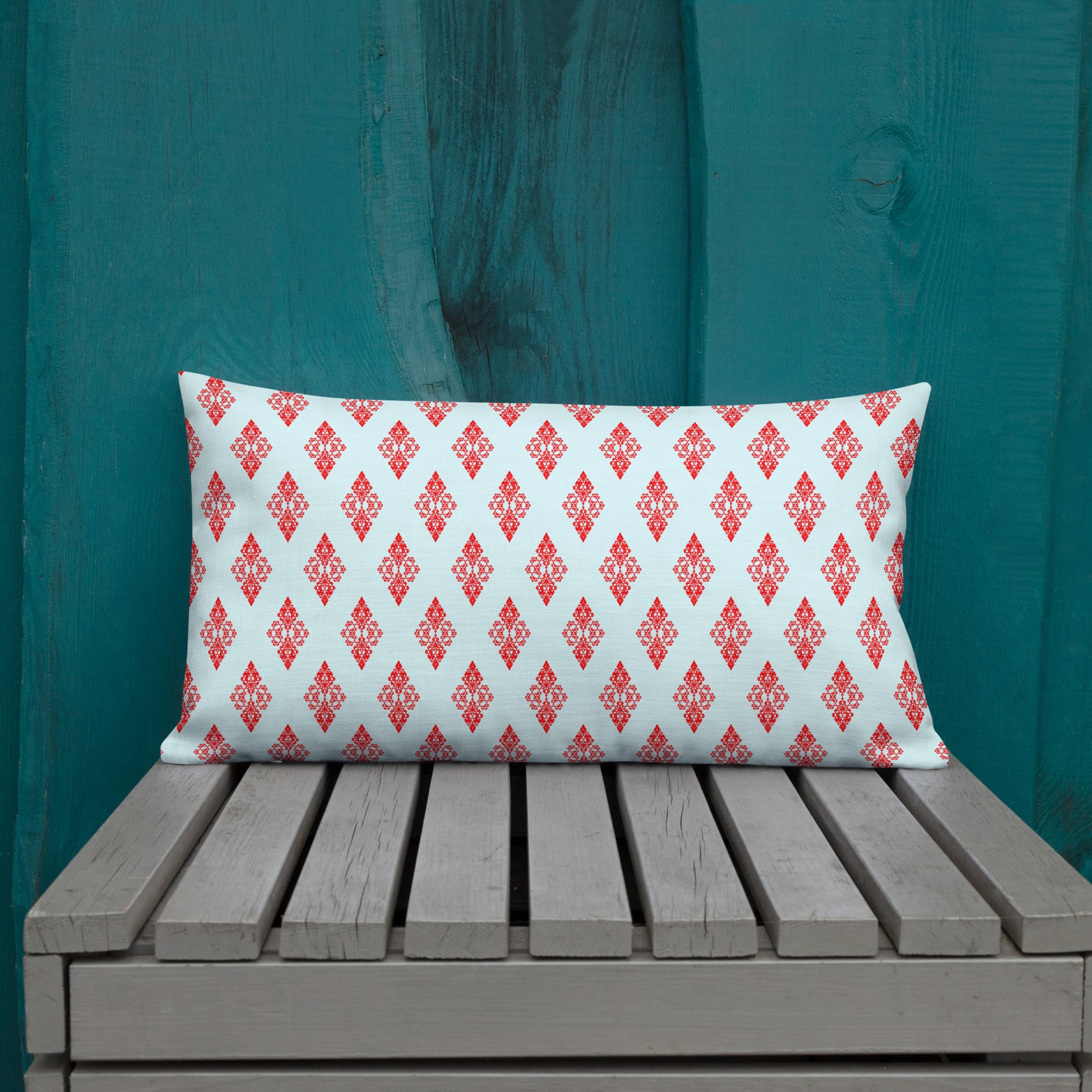20″×12″ premium throw pillow with the 'Digon' sky blue and red geometric pattern shown in a lifestyle setting.