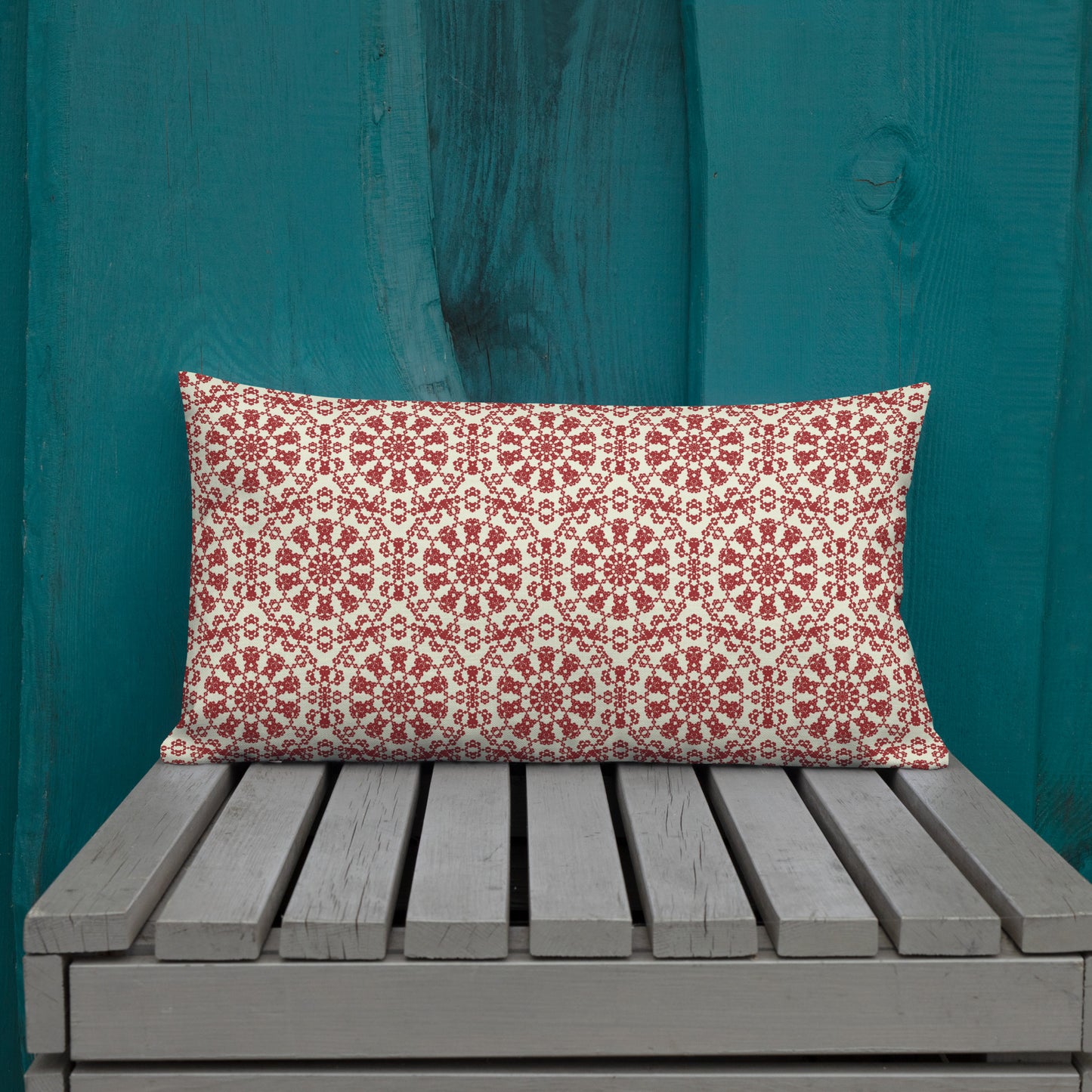 20″×12″ premium throw pillow with the ‘Decagon’ terracotta and beige geometric pattern on an outdoor bench with a teal wooden backdrop.