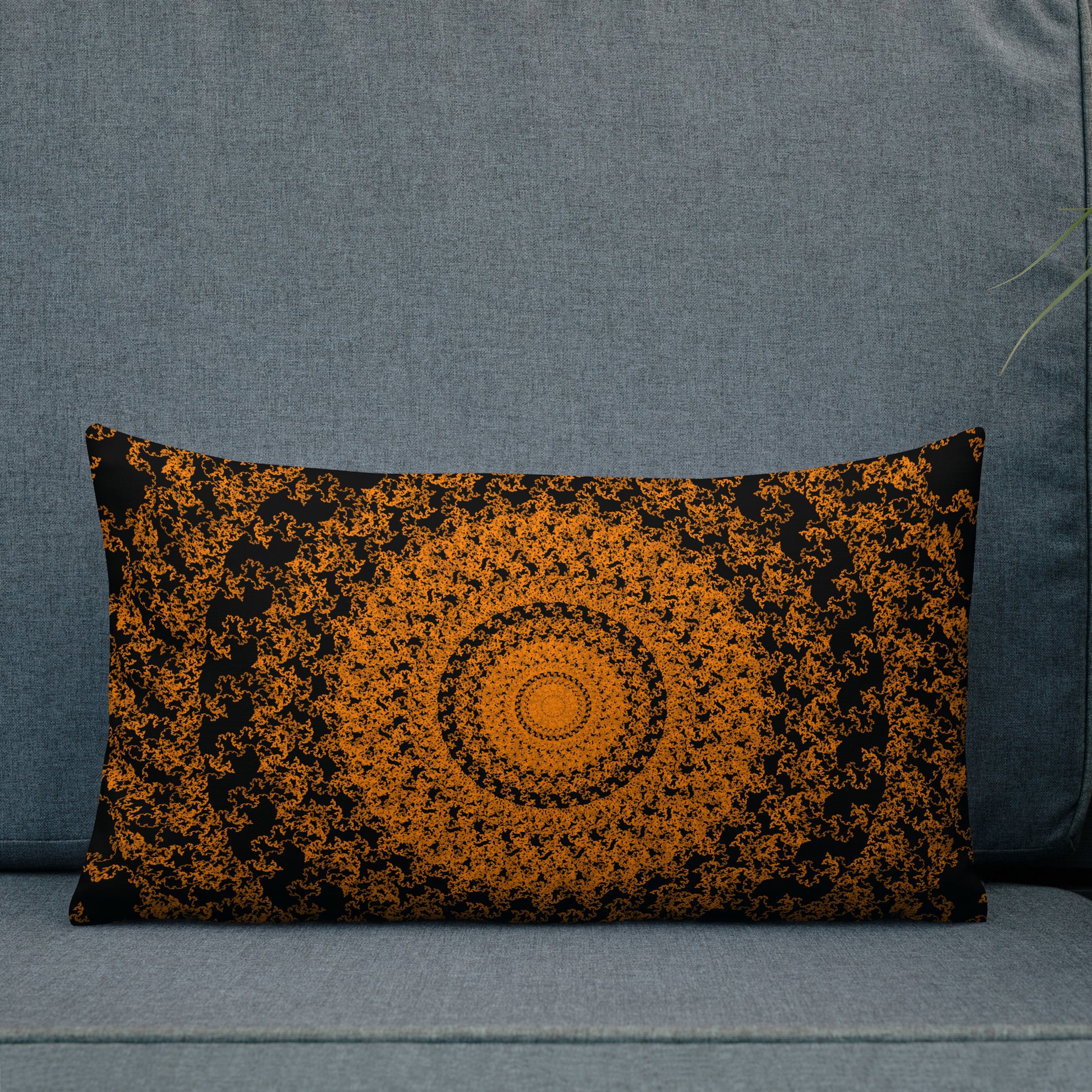 20″×12″ premium throw pillow with the 'The Sun' orange and black geometric design shown in a lifestyle setting.