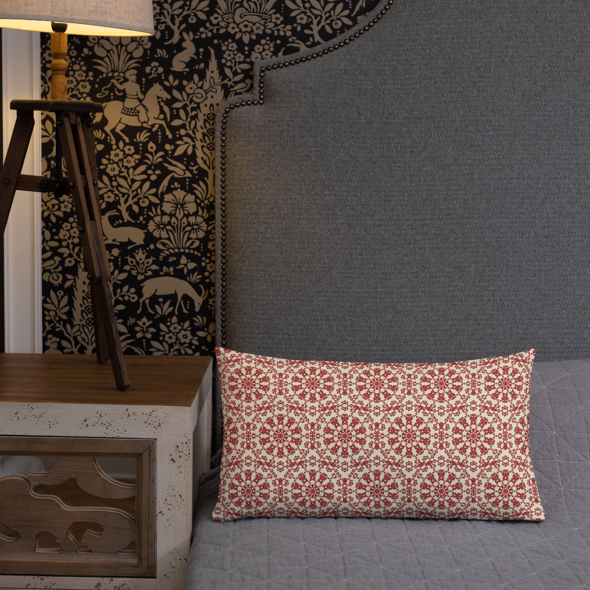 20″×12″ premium throw pillow with the ‘Decagon’ terracotta and beige geometric pattern on a grey bed with an ornate headboard.