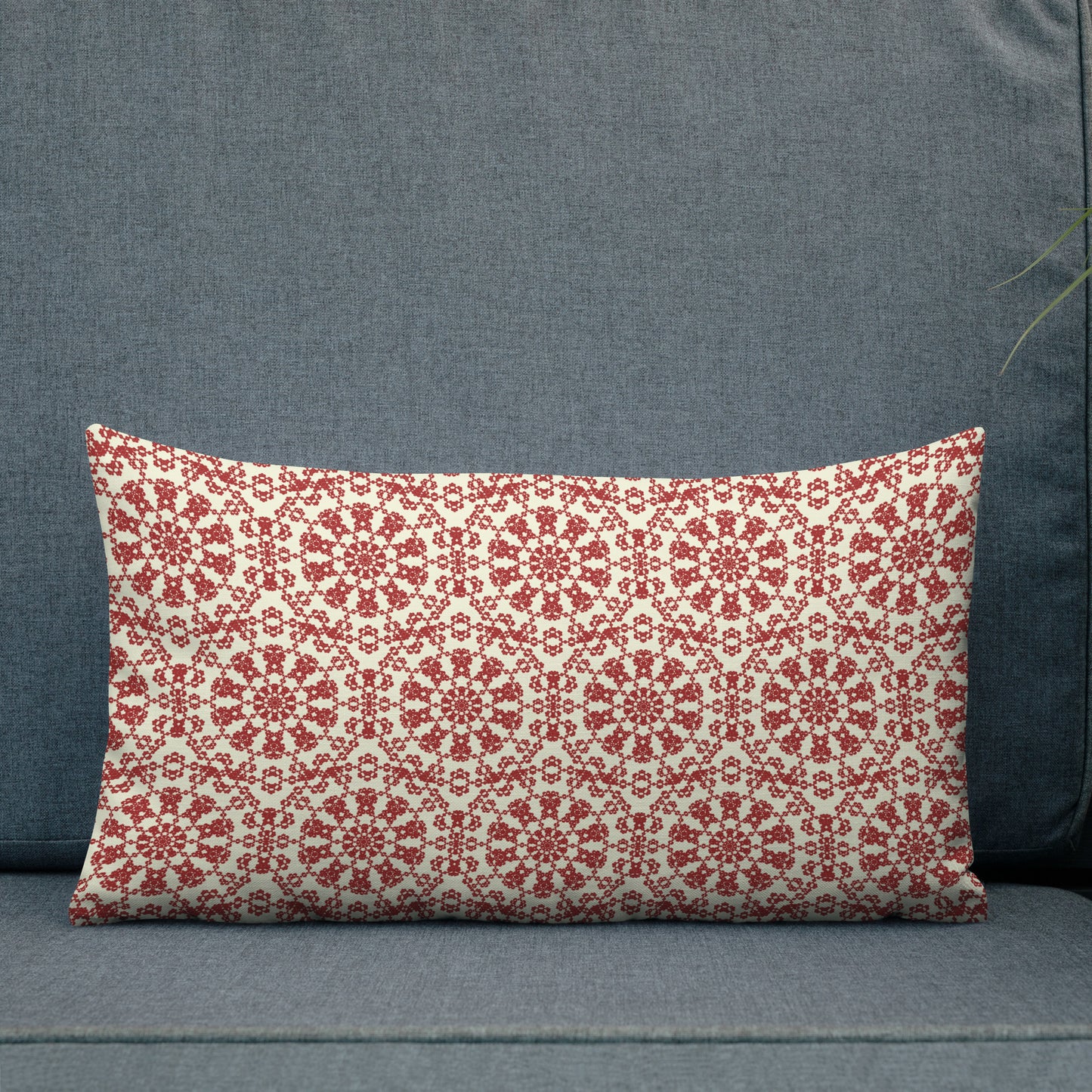 20″×12″ premium throw pillow with the ‘Decagon’ terracotta and beige geometric pattern on a dark teal sofa.