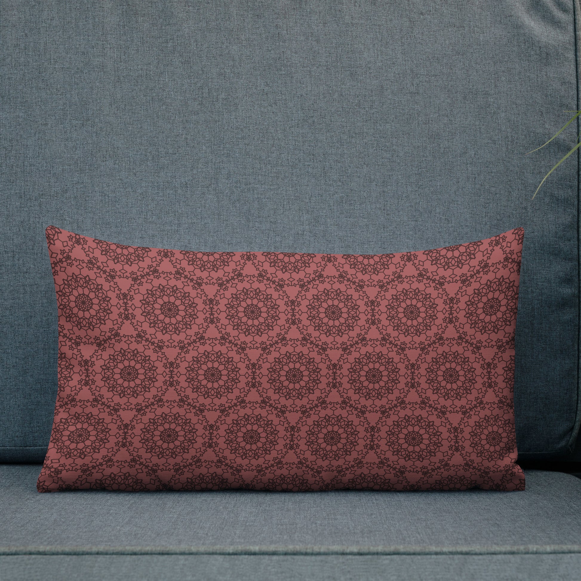 20″×12″ premium throw pillow with the 'Dodecagon' rose geometric pattern on grey outdoor sofa.