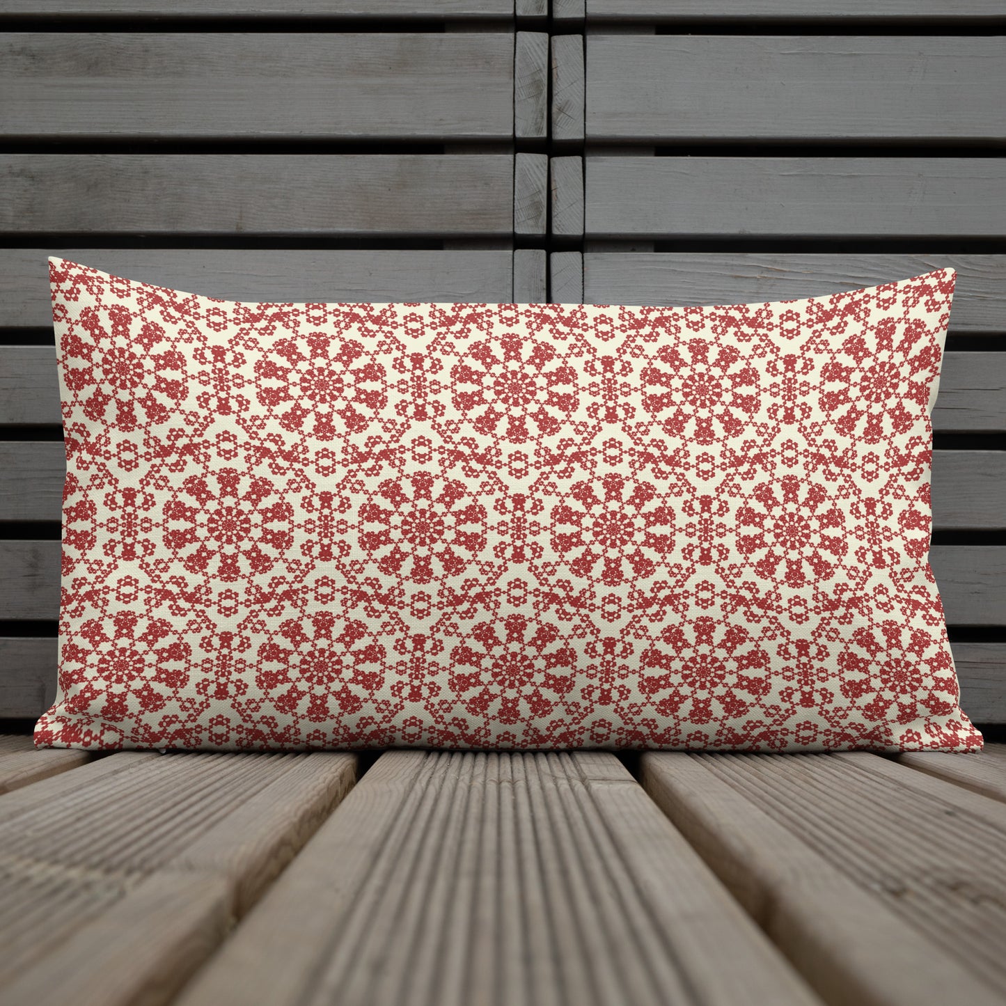 20″×12″ premium throw pillow with the ‘Decagon’ terracotta and beige geometric pattern on a weathered wooden deck.