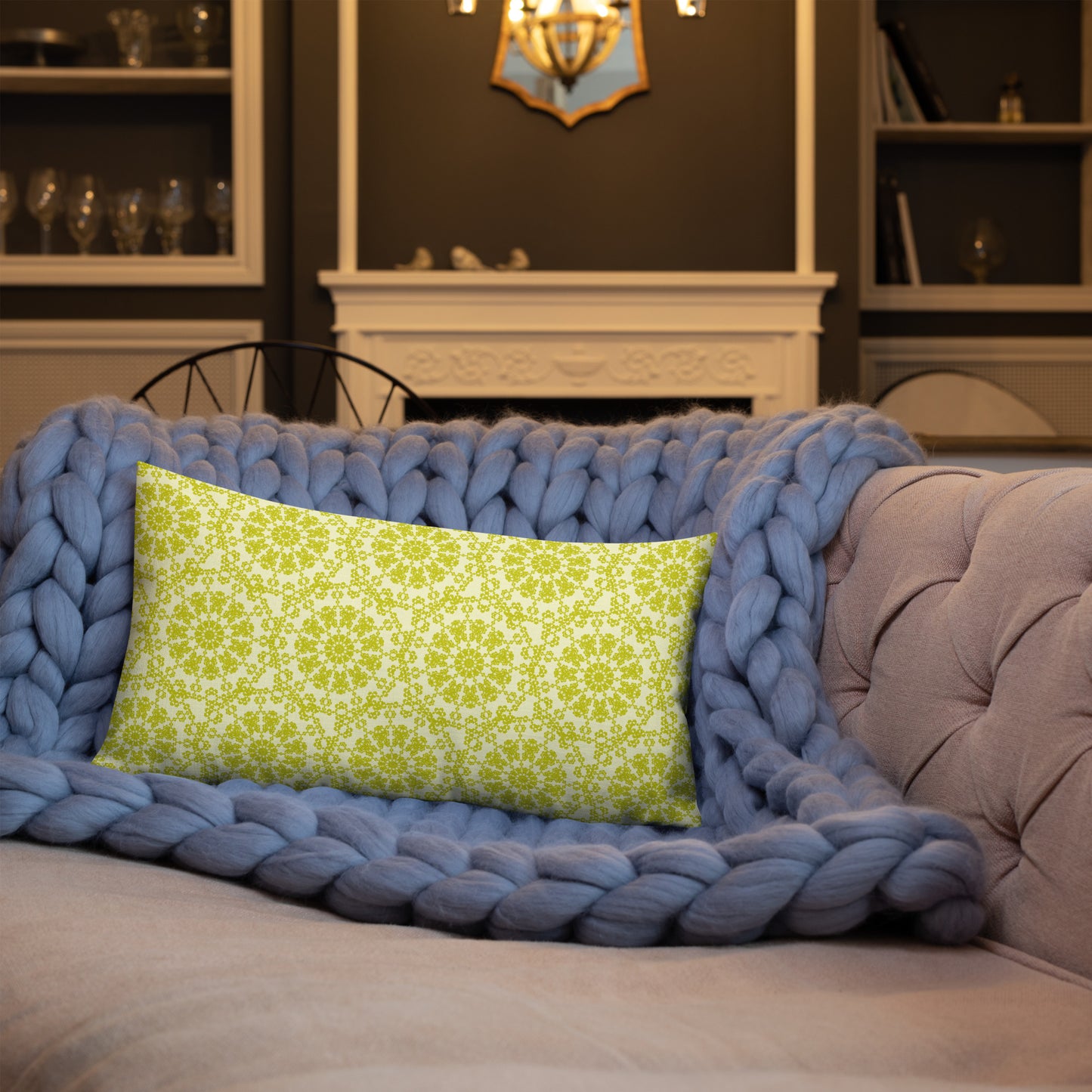 20″×12″ premium throw pillow with the 'Hendecagon' yellow-green geometric pattern on a sofa with chunky knit blanket