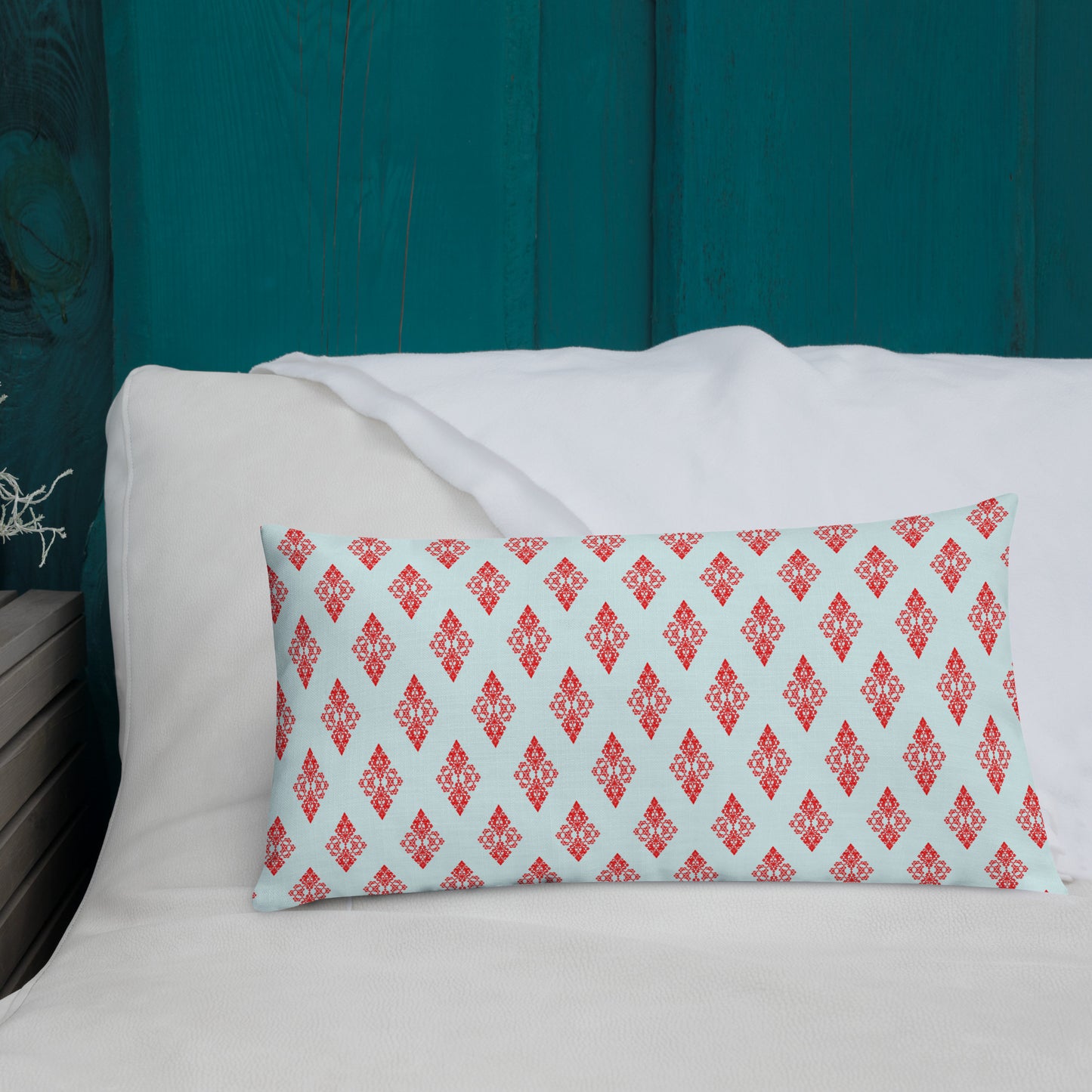 20″×12″ premium throw pillow with the 'Digon' sky blue and red geometric pattern shown in a lifestyle setting.