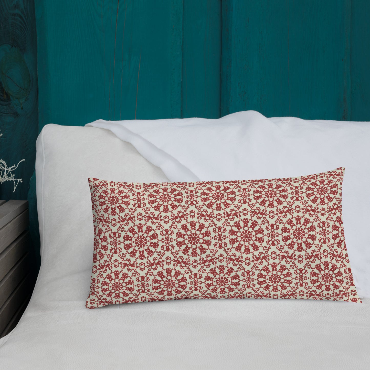 20″×12″ premium throw pillow with the ‘Decagon’ terracotta and beige geometric pattern on a white bed with a teal wooden headboard.