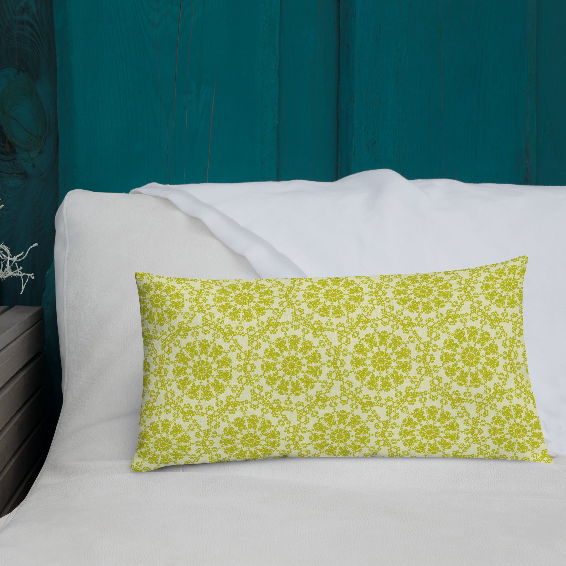 20″×12″ premium throw pillow with the 'Hendecagon' yellow-green geometric pattern on a bed with teal headboard