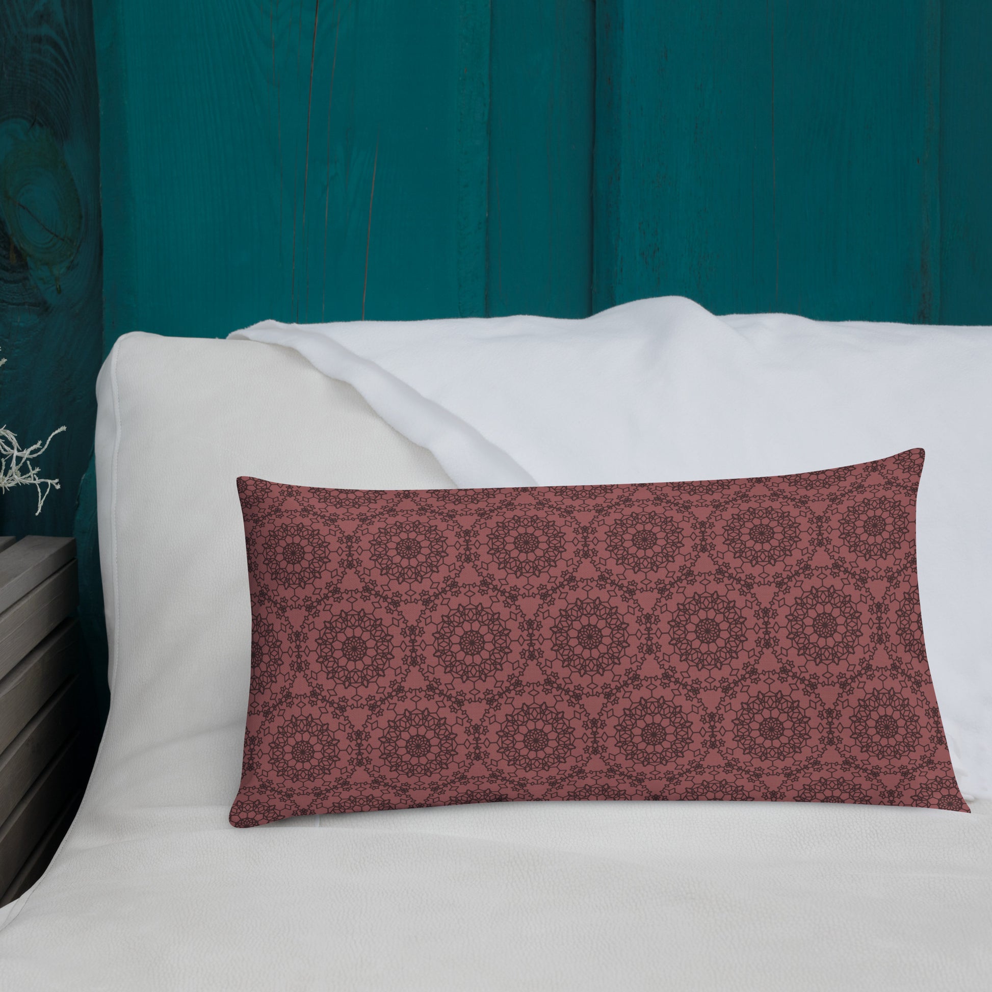 20″×12″ premium throw pillow with the 'Dodecagon' rose geometric pattern on white sofa with teal wooden wall.