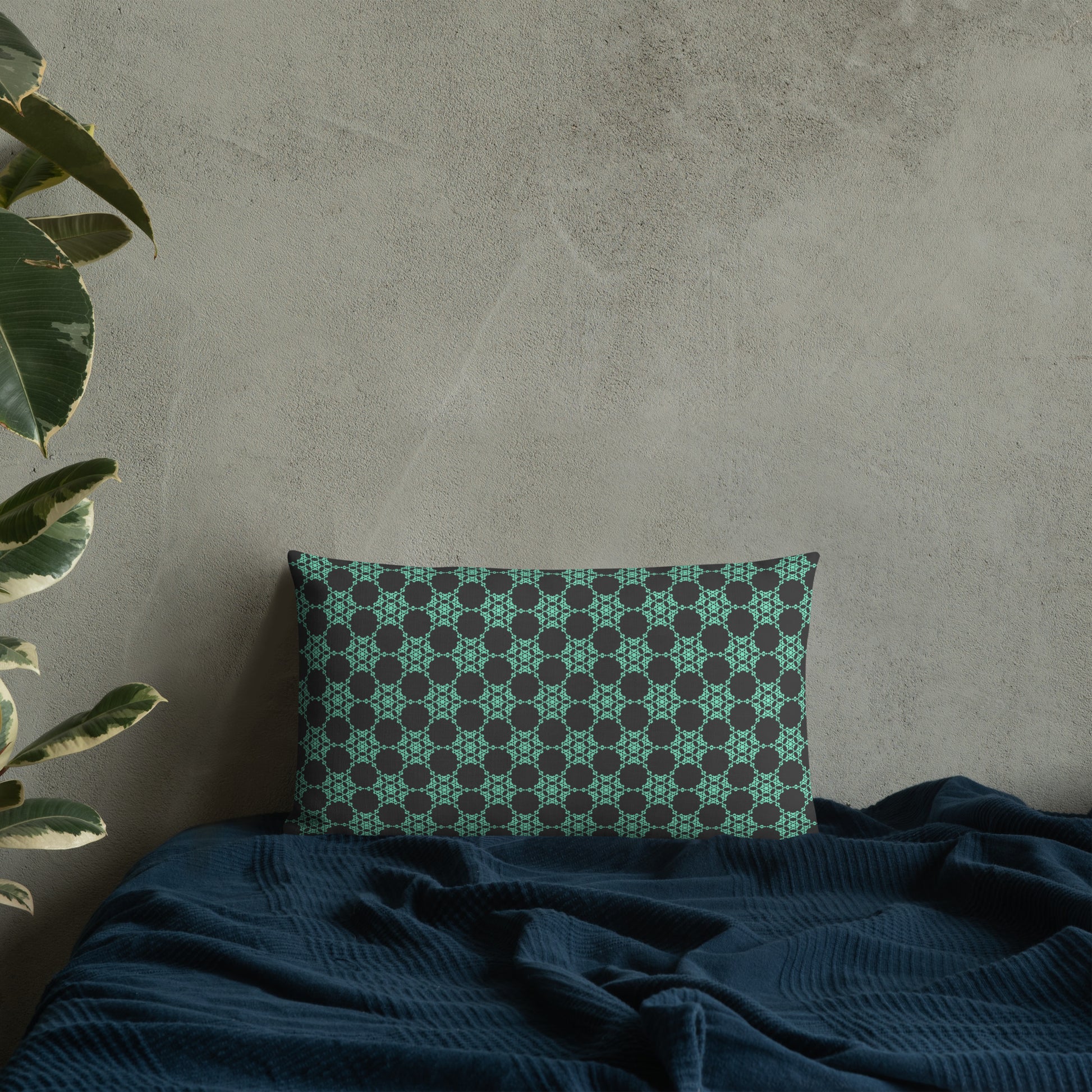 20″×12″ premium throw pillow with the 'Flowers Victory' charcoal and mint geometric pattern on a bed.