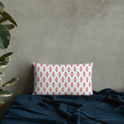 20″×12″ premium throw pillow with the 'Digon' sky blue and red geometric pattern on a bed.