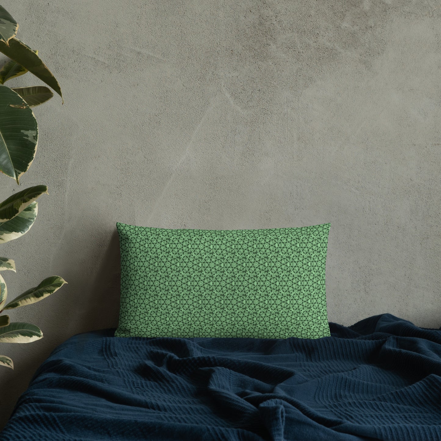 20″×12″ premium throw pillow with the 'Heptagon' green geometric pattern on a bed.