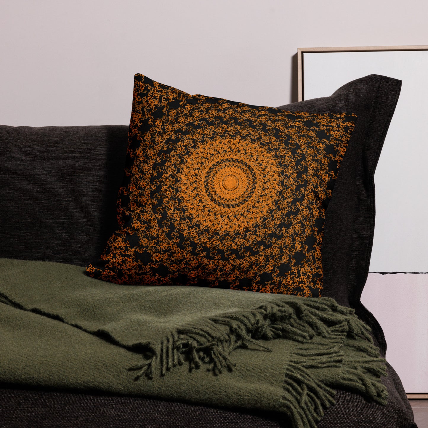 22″×22″ premium throw pillow with the 'The Sun' orange and black geometric design on a couch.