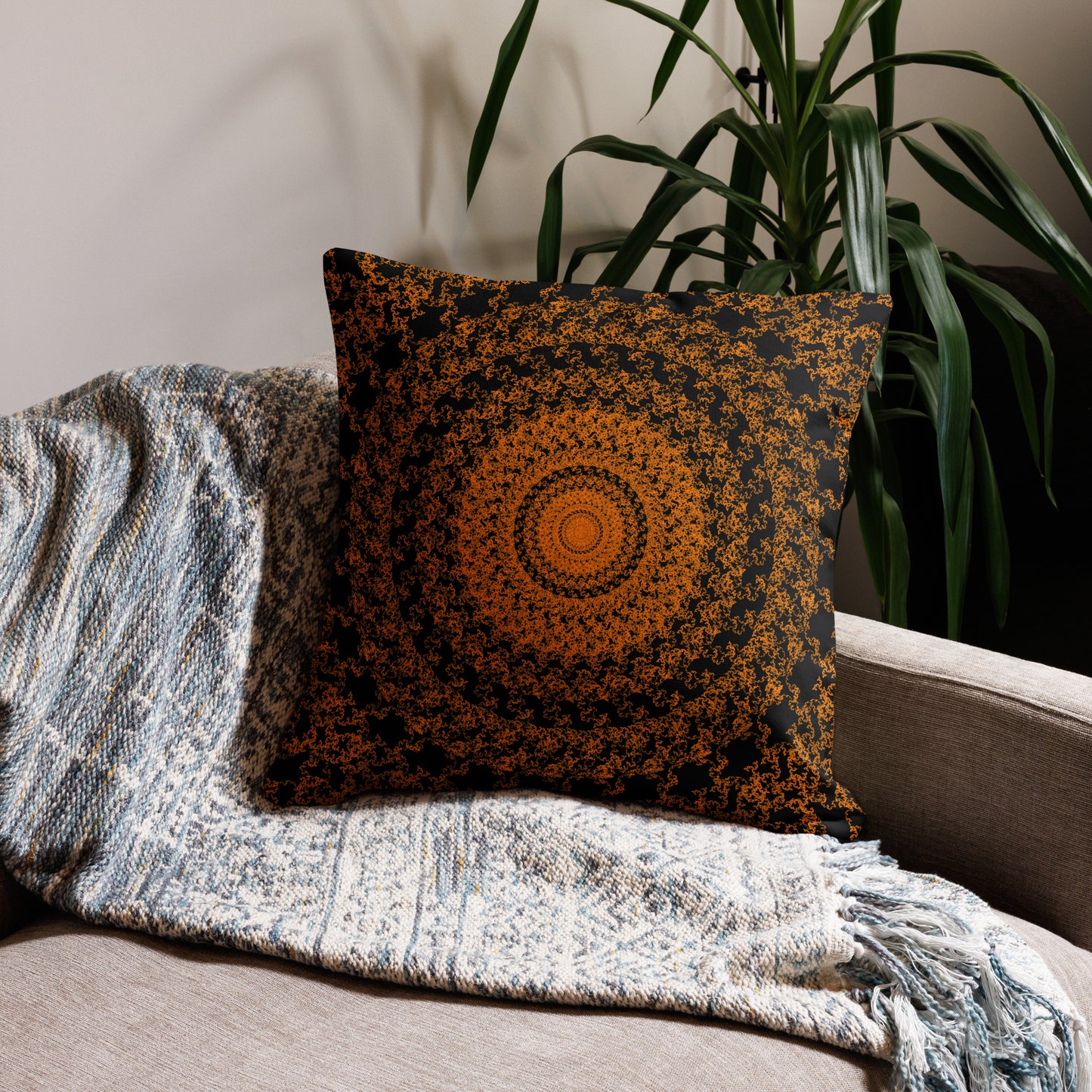 22″×22″ premium throw pillow with the 'The Sun' orange and black geometric design on a couch.