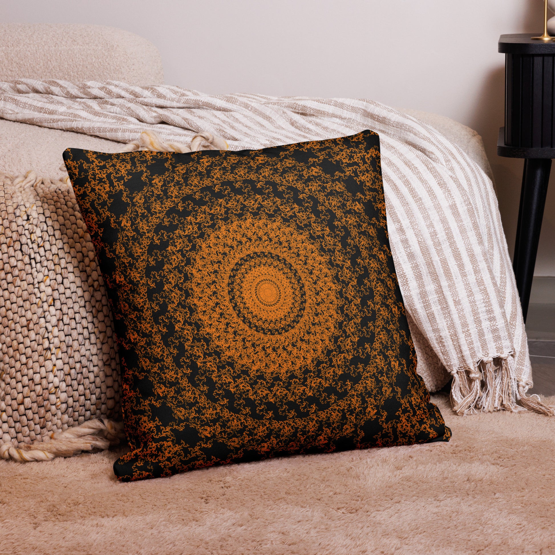 22″×22″ premium throw pillow with the 'The Sun' orange and black geometric design on a couch.