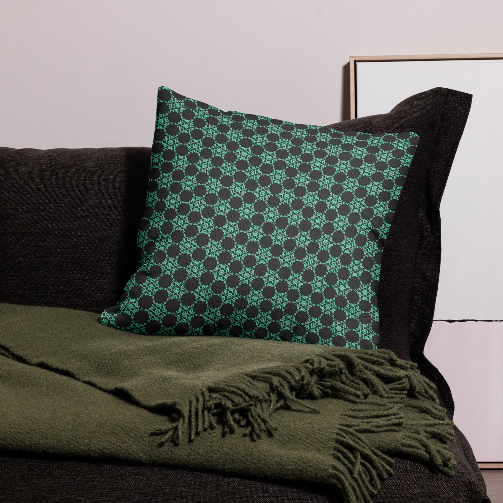 22″×22″ premium throw pillow with the 'Flowers Victory' charcoal and mint geometric pattern on a couch.