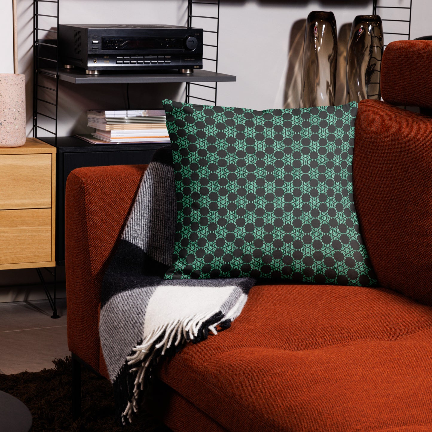 22″×22″ premium throw pillow with the 'Flowers Victory' charcoal and mint geometric pattern on a couch.
