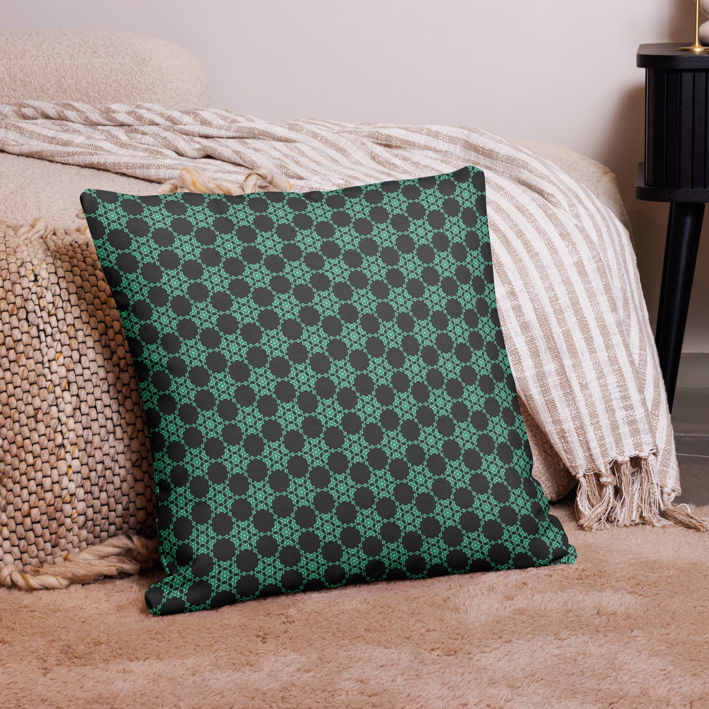 22″×22″ premium throw pillow with the 'Flowers Victory' charcoal and mint geometric pattern on a couch.