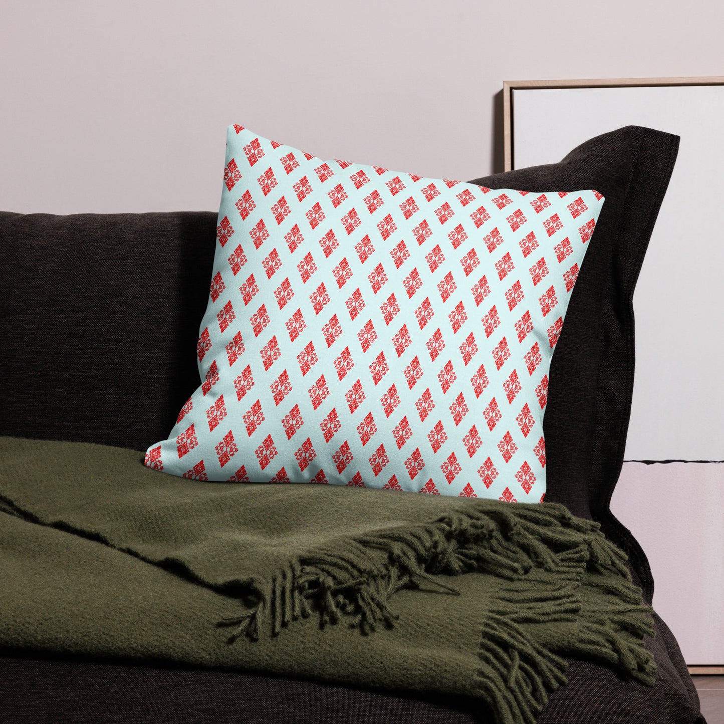 22″×22″ premium throw pillow with the 'Digon' sky blue and red geometric pattern on a couch.