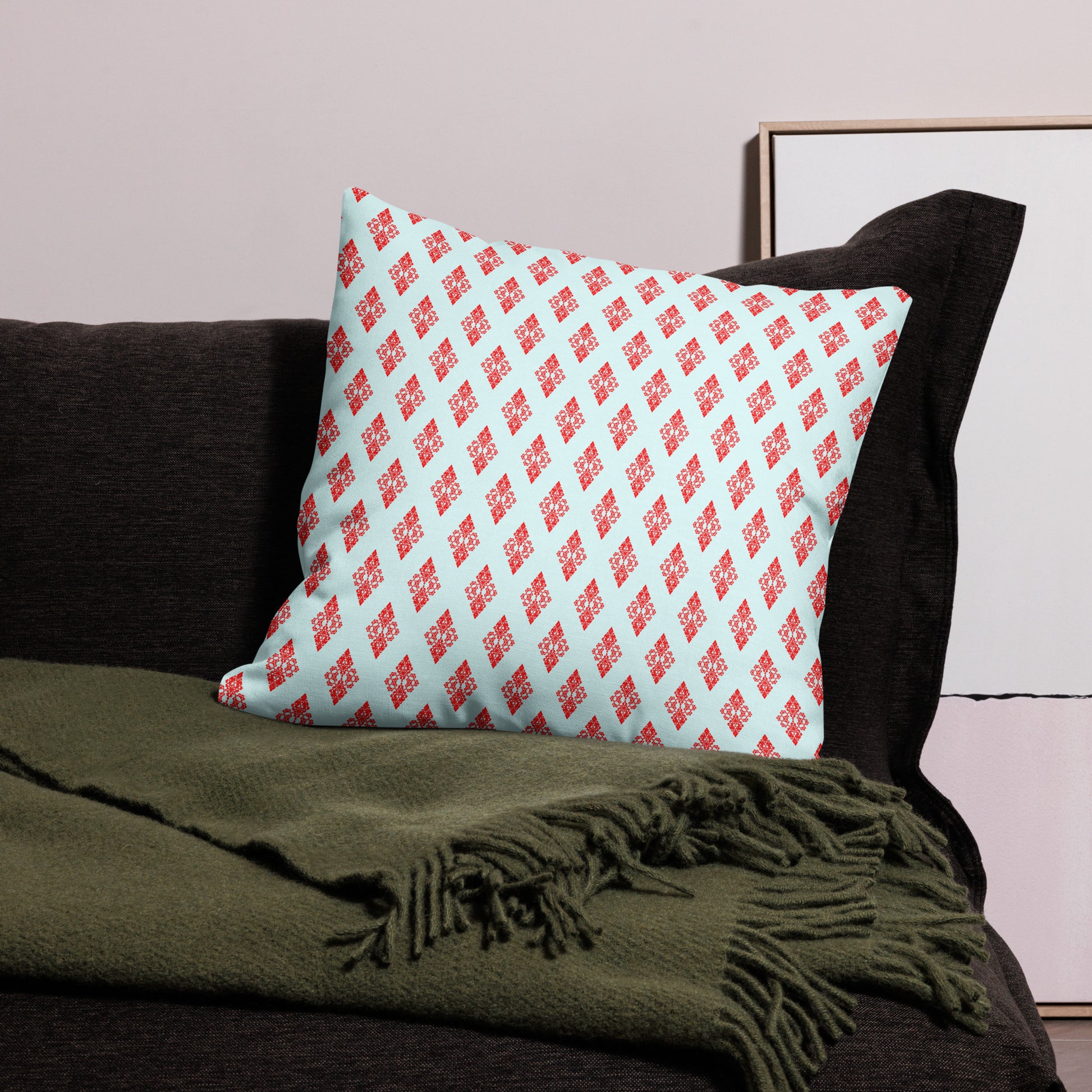 22″×22″ premium throw pillow with the 'Digon' sky blue and red geometric pattern on a couch.