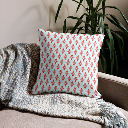 22″×22″ premium throw pillow with the 'Digon' sky blue and red geometric pattern on a couch.