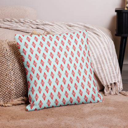 22″×22″ premium throw pillow with the 'Digon' sky blue and red geometric pattern on a couch.