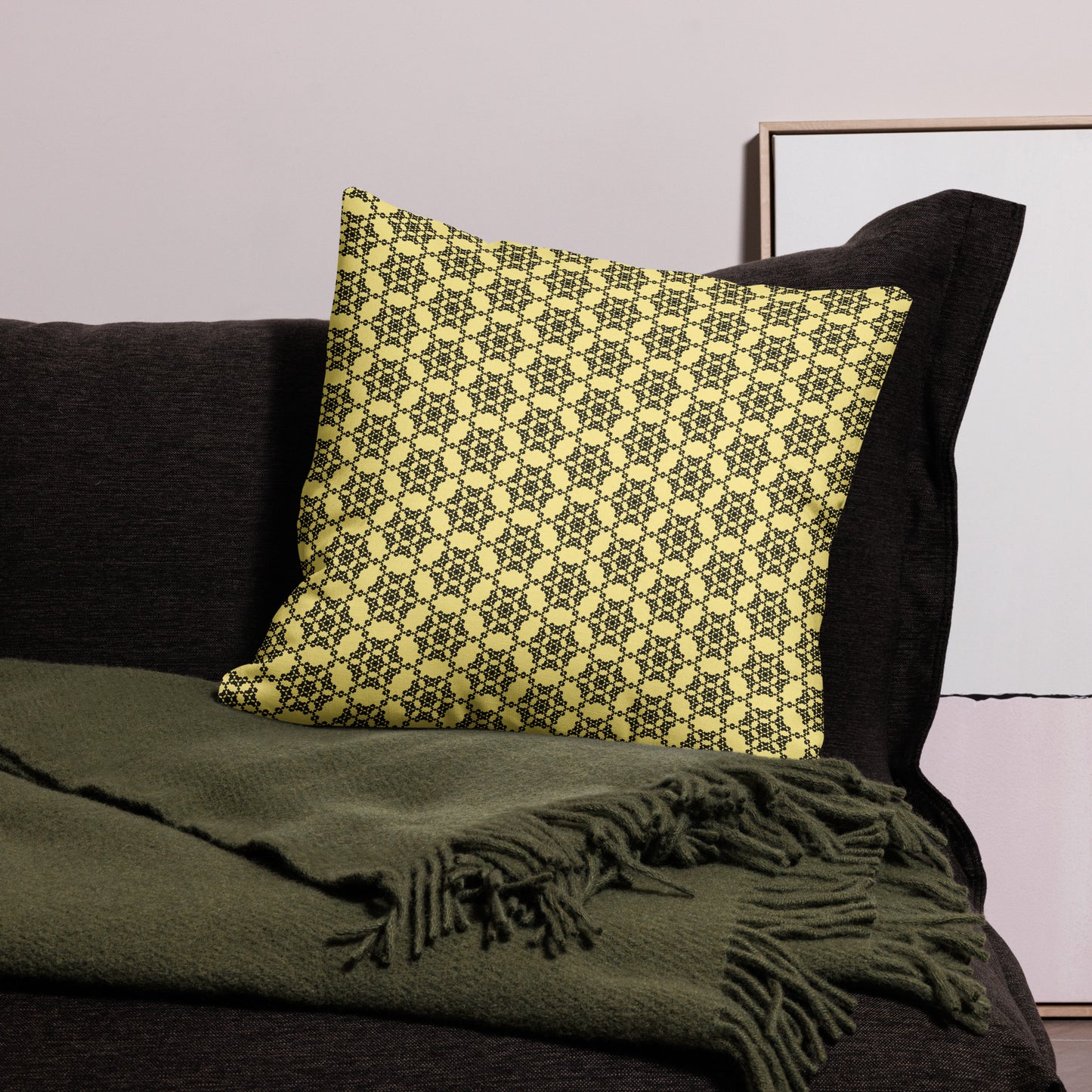22″×22″ premium throw pillow with the 'Hexagon' yellow and black geometric pattern on a couch.