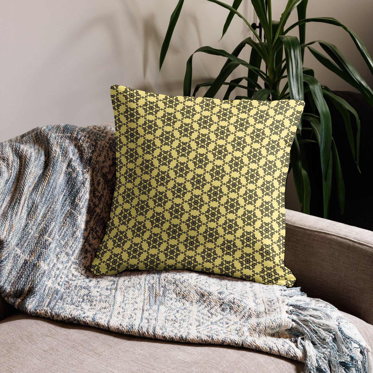 22″×22″ premium throw pillow with the 'Hexagon' yellow and black geometric pattern on a couch.