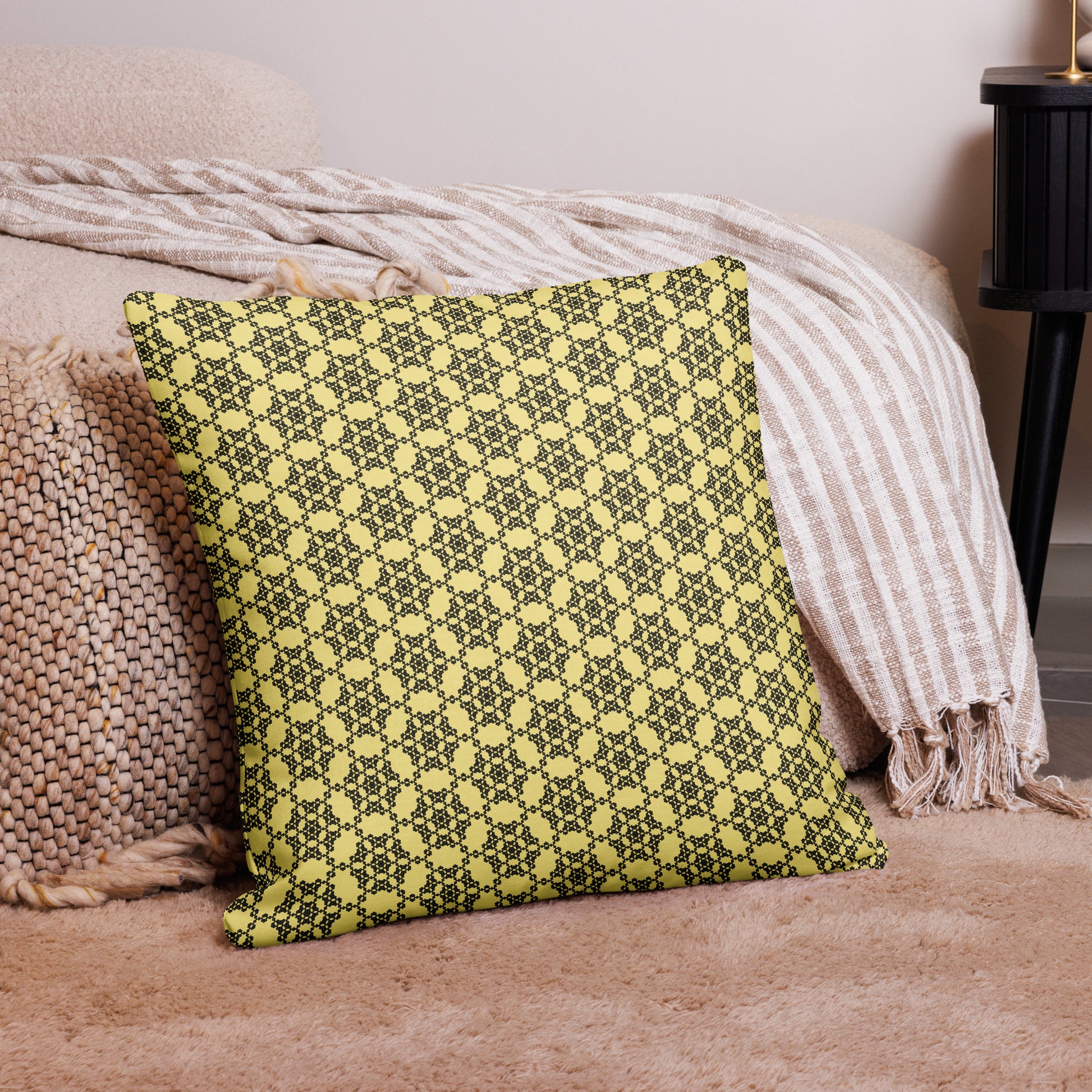 22″×22″ premium throw pillow with the 'Hexagon' yellow and black geometric pattern on a couch.