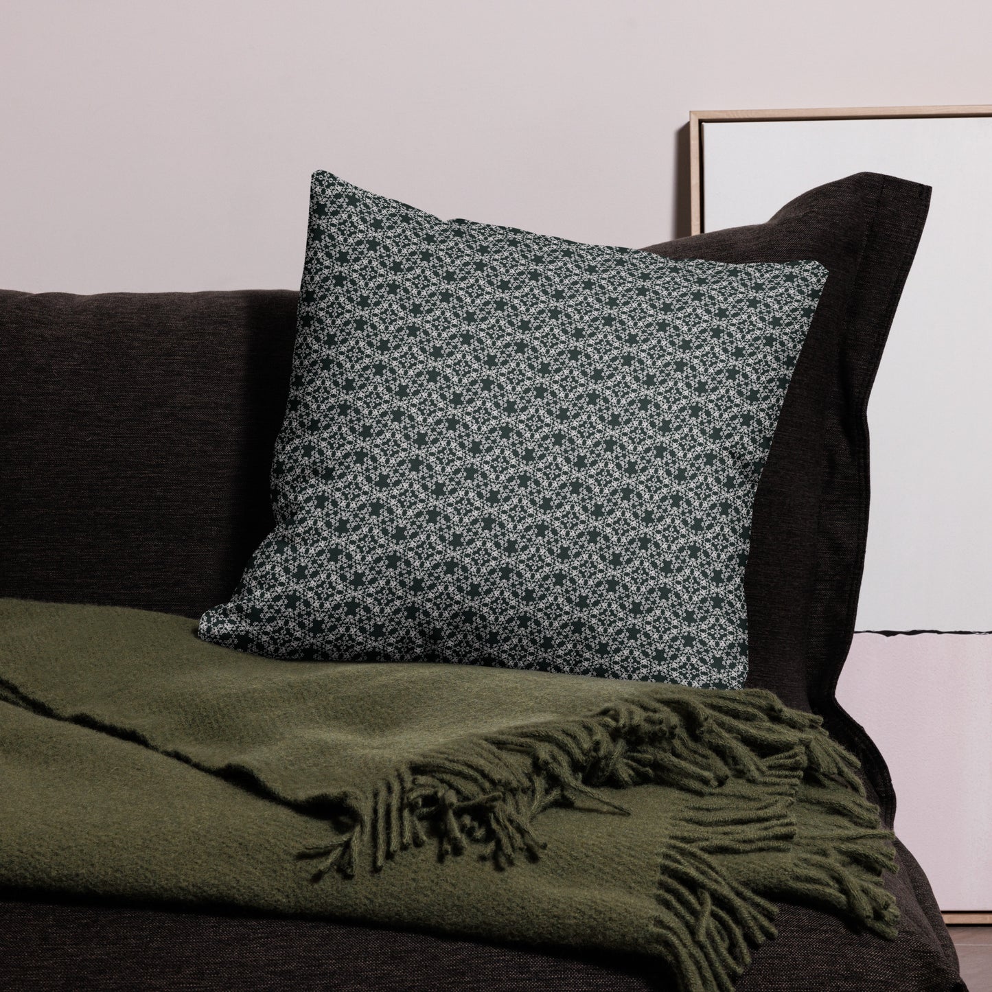 22″×22″ premium throw pillow with the 'Tetragon' charcoal and white geometric pattern on a couch.