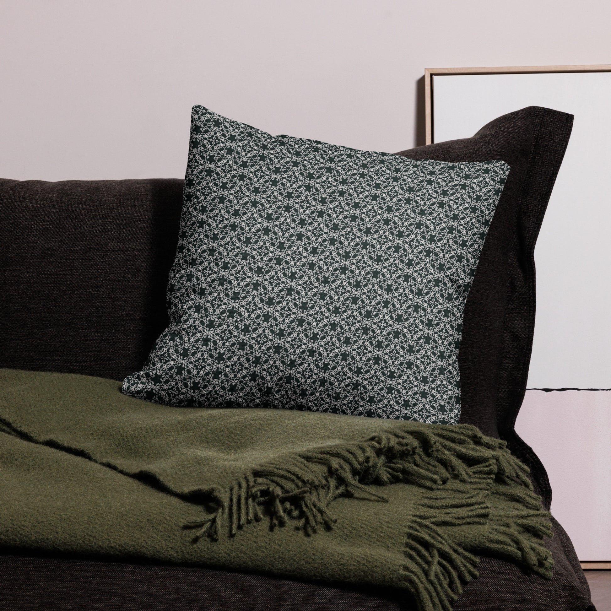 22″×22″ premium throw pillow with the 'Tetragon' charcoal and white geometric pattern on a couch.