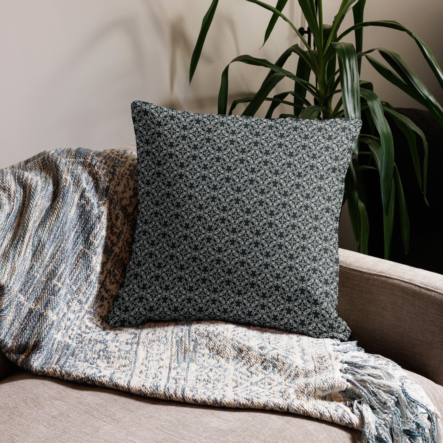 22″×22″ premium throw pillow with the 'Tetragon' charcoal and white geometric pattern on a couch.