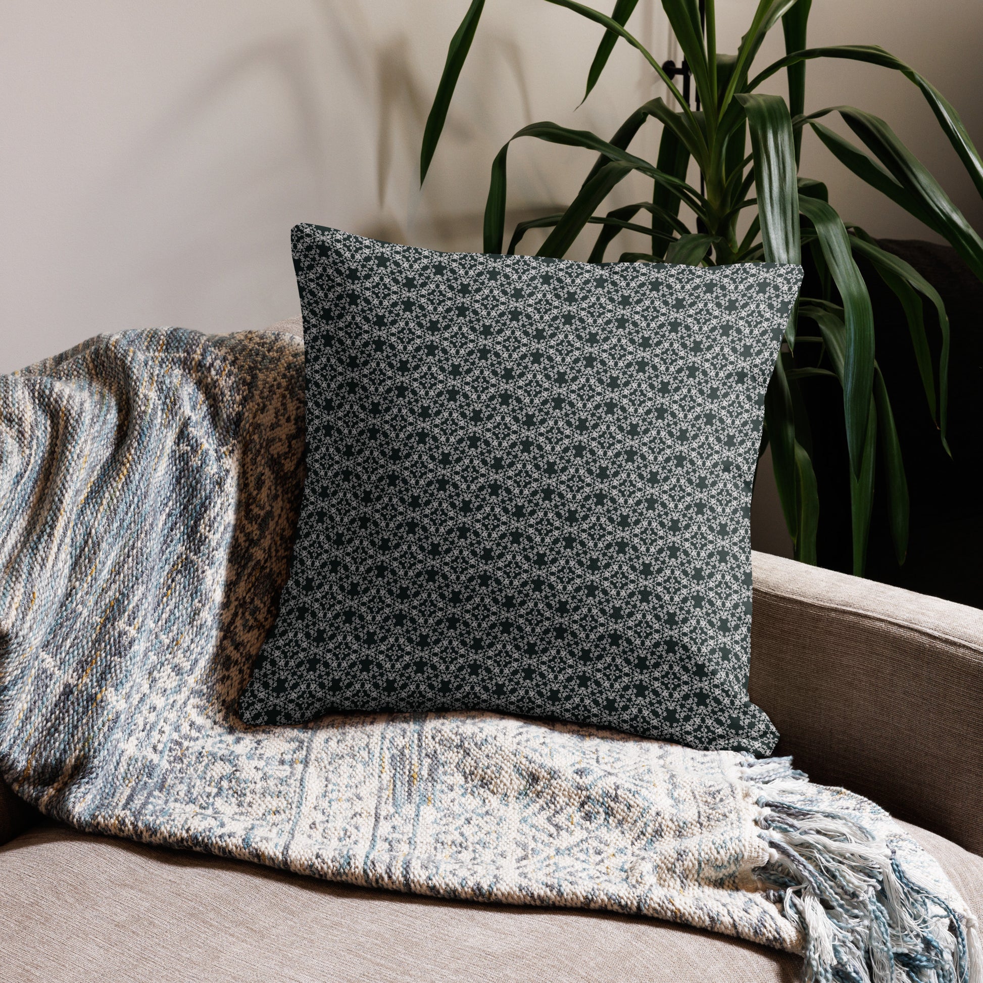 22″×22″ premium throw pillow with the 'Tetragon' charcoal and white geometric pattern on a couch.