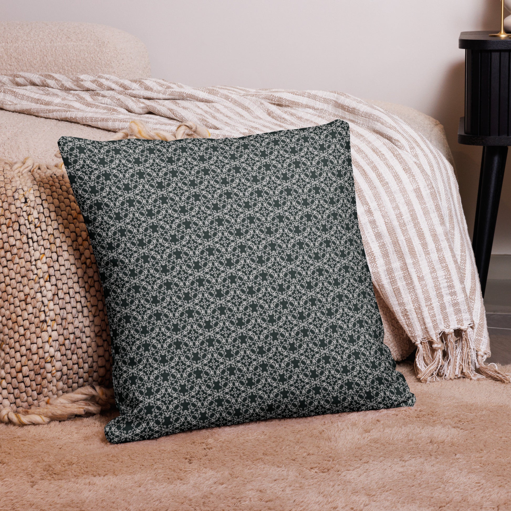 22″×22″ premium throw pillow with the 'Tetragon' charcoal and white geometric pattern on a couch.