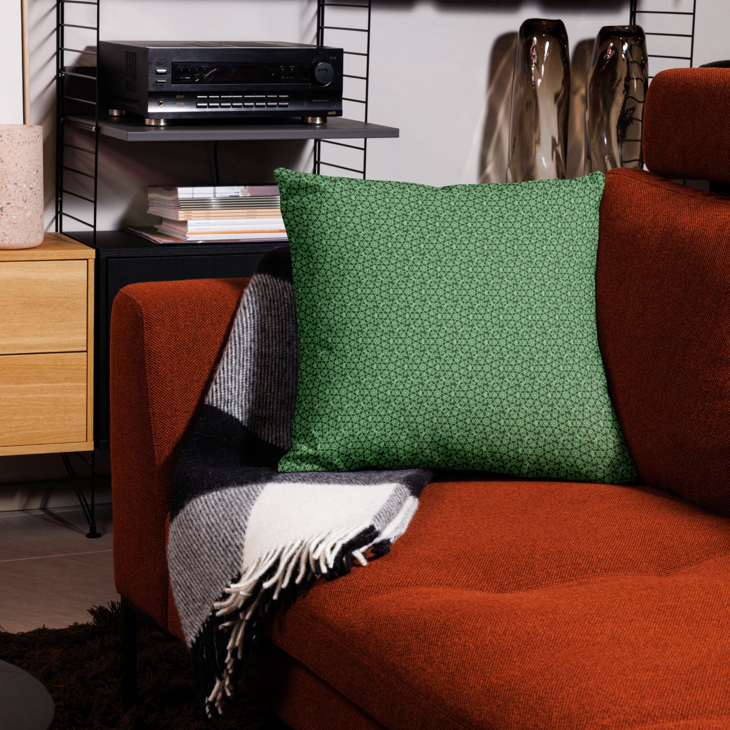 22″×22″ premium throw pillow with the 'Heptagon' green geometric pattern on a couch.