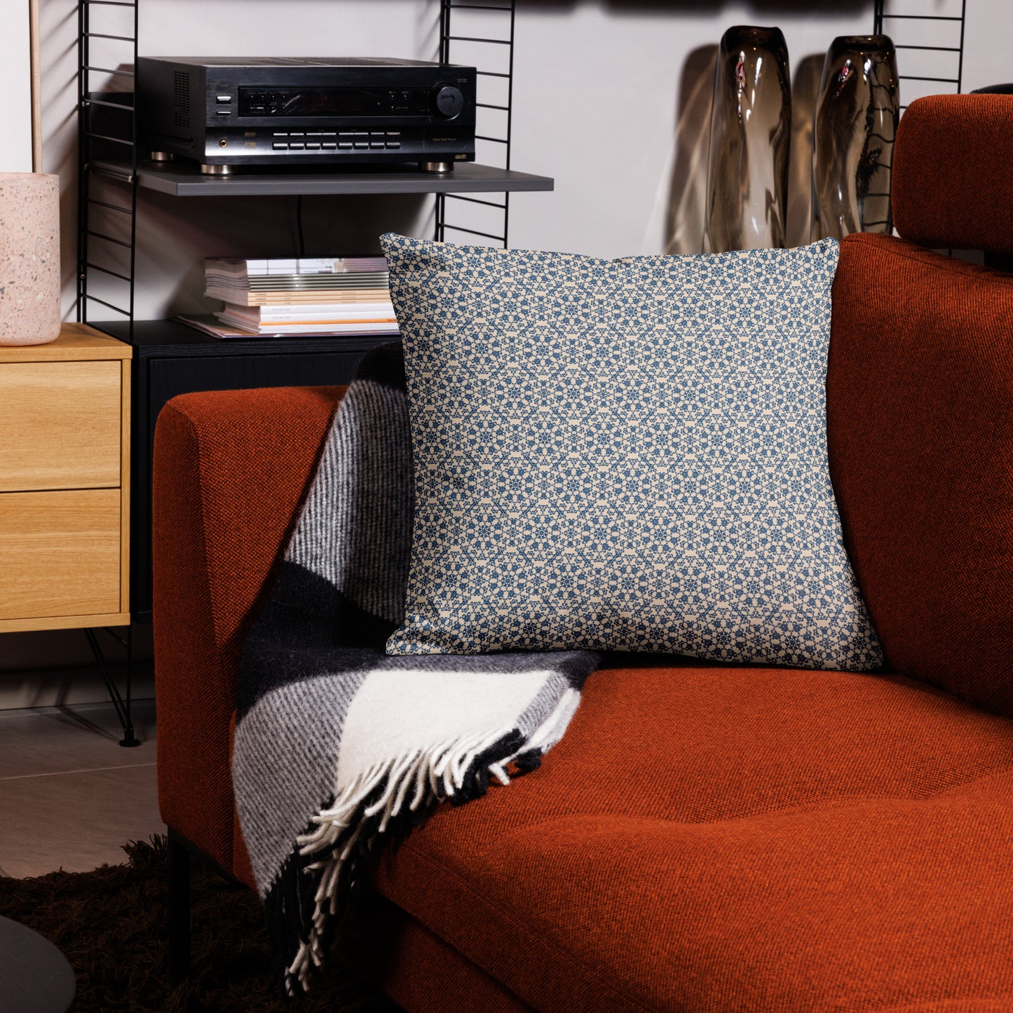22″×22″ premium throw pillow with the ‘Octagon’ navy and beige geometric pattern on an armchair.