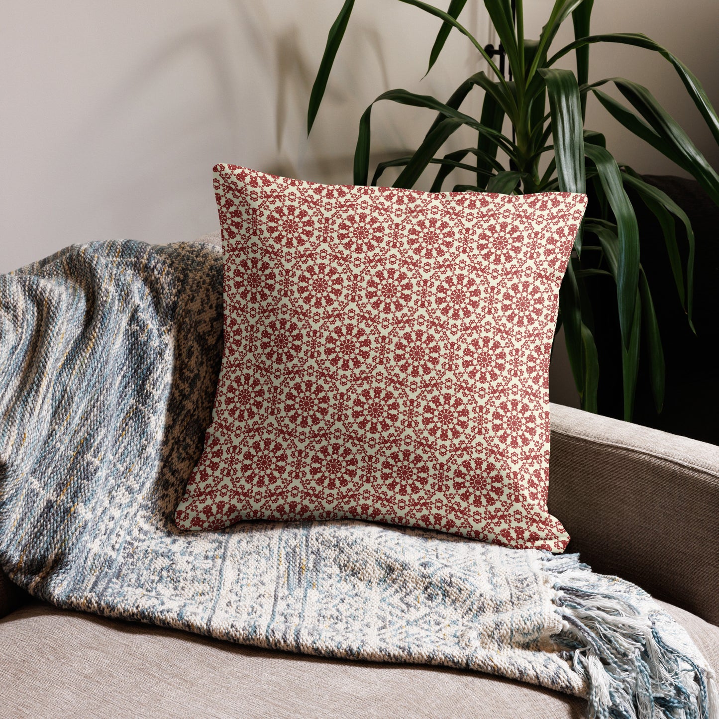 22″×22″ premium throw pillow with the ‘Decagon’ terracotta and beige geometric pattern on a beige sofa with a woven throw.