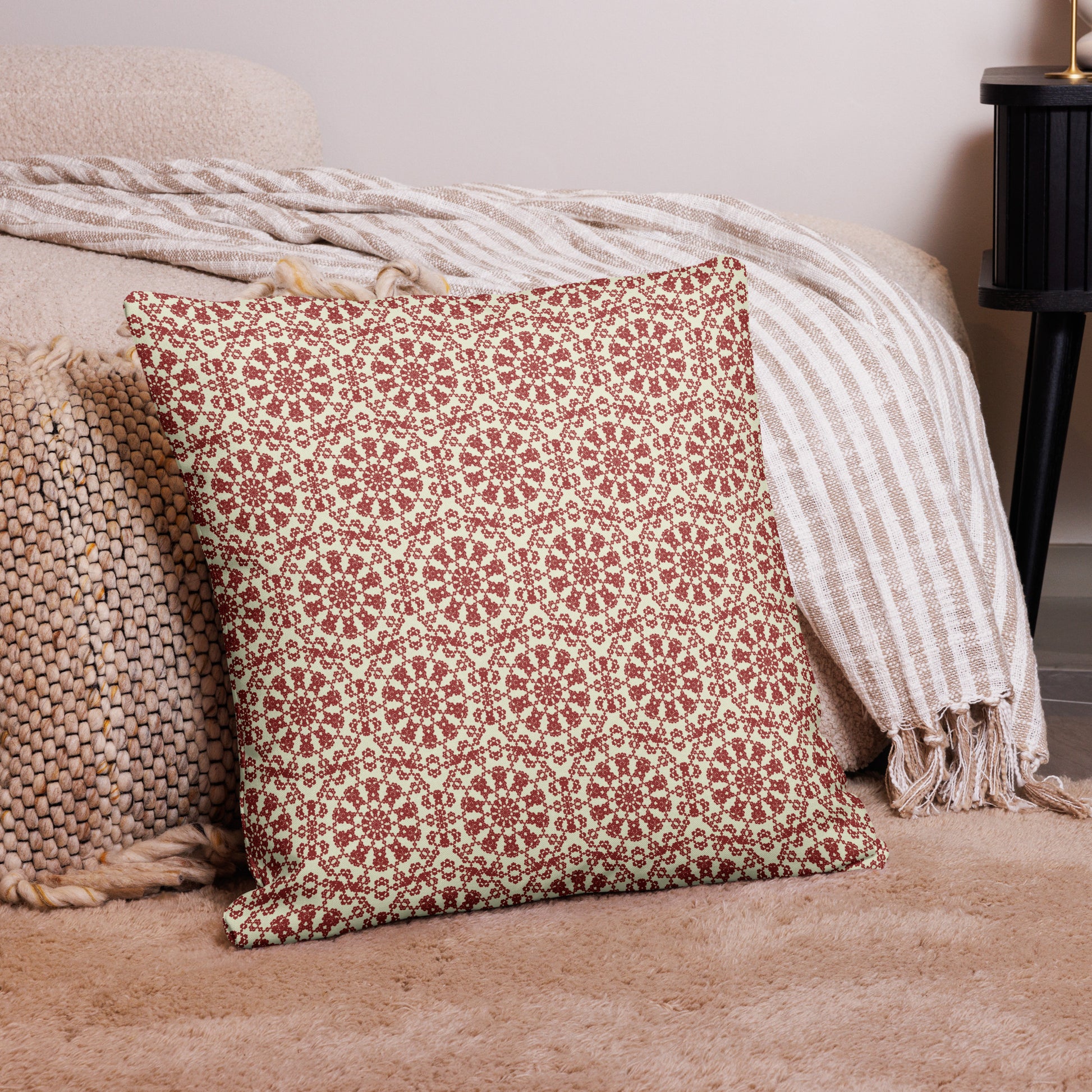 22″×22″ premium throw pillow with the ‘Decagon’ terracotta and beige geometric pattern on a bedroom floor with striped linen throws.