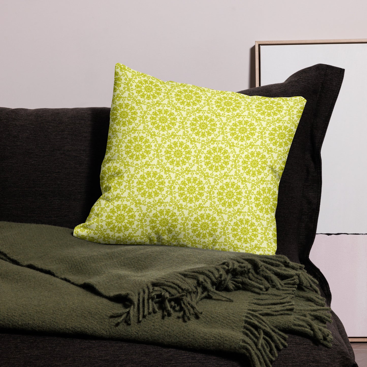22″×22″ premium throw pillow with the 'Hendecagon' yellow-green geometric pattern on a dark sofa with green throw