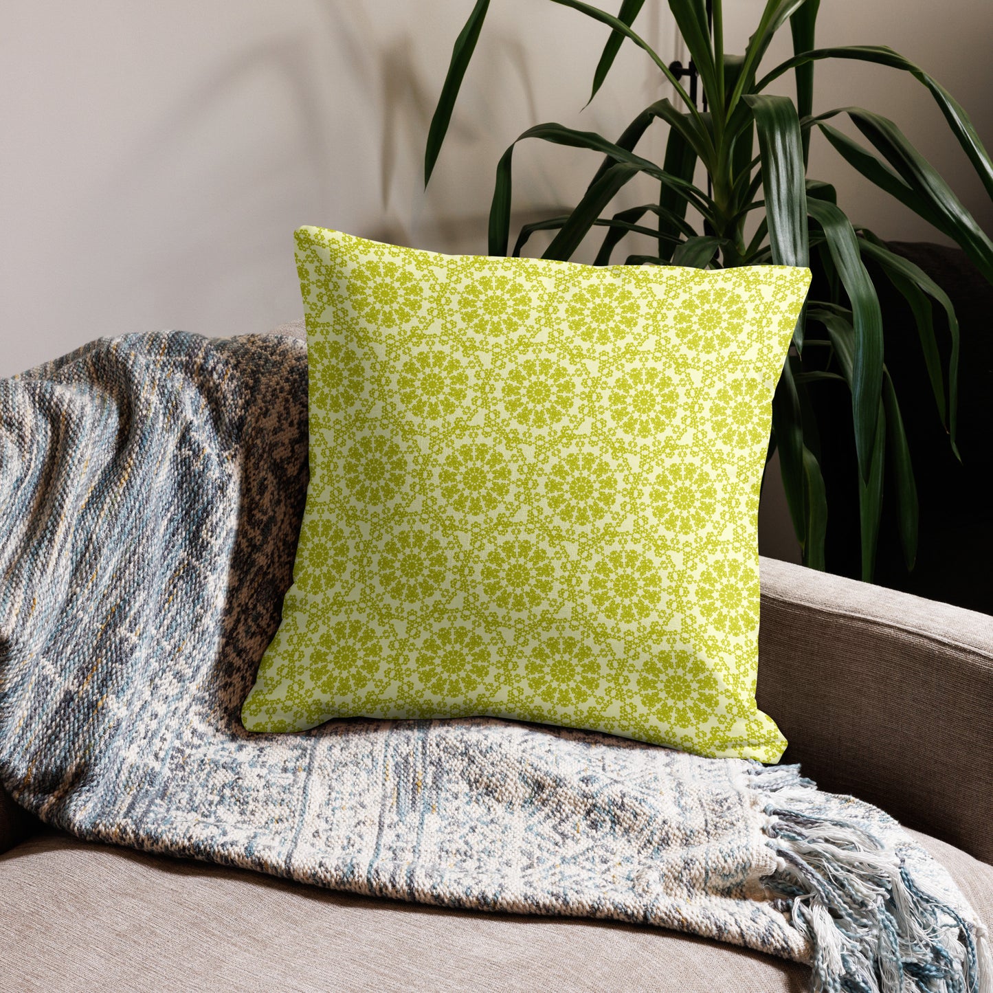 22″×22″ premium throw pillow with the 'Hendecagon' yellow-green geometric pattern on a beige sofa with woven throw