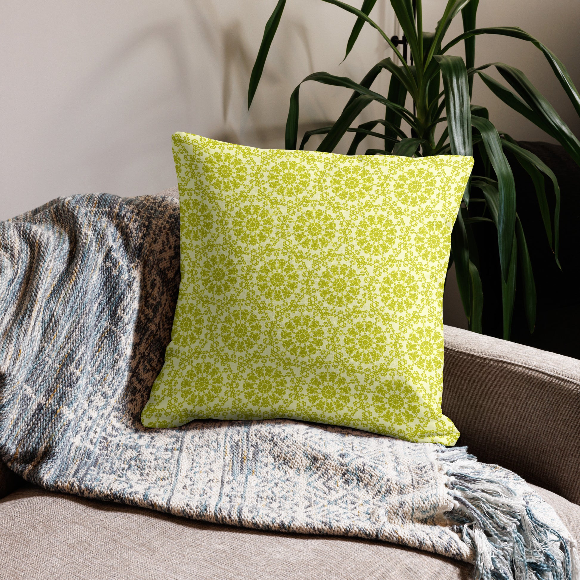 22″×22″ premium throw pillow with the 'Hendecagon' yellow-green geometric pattern on a beige sofa with woven throw