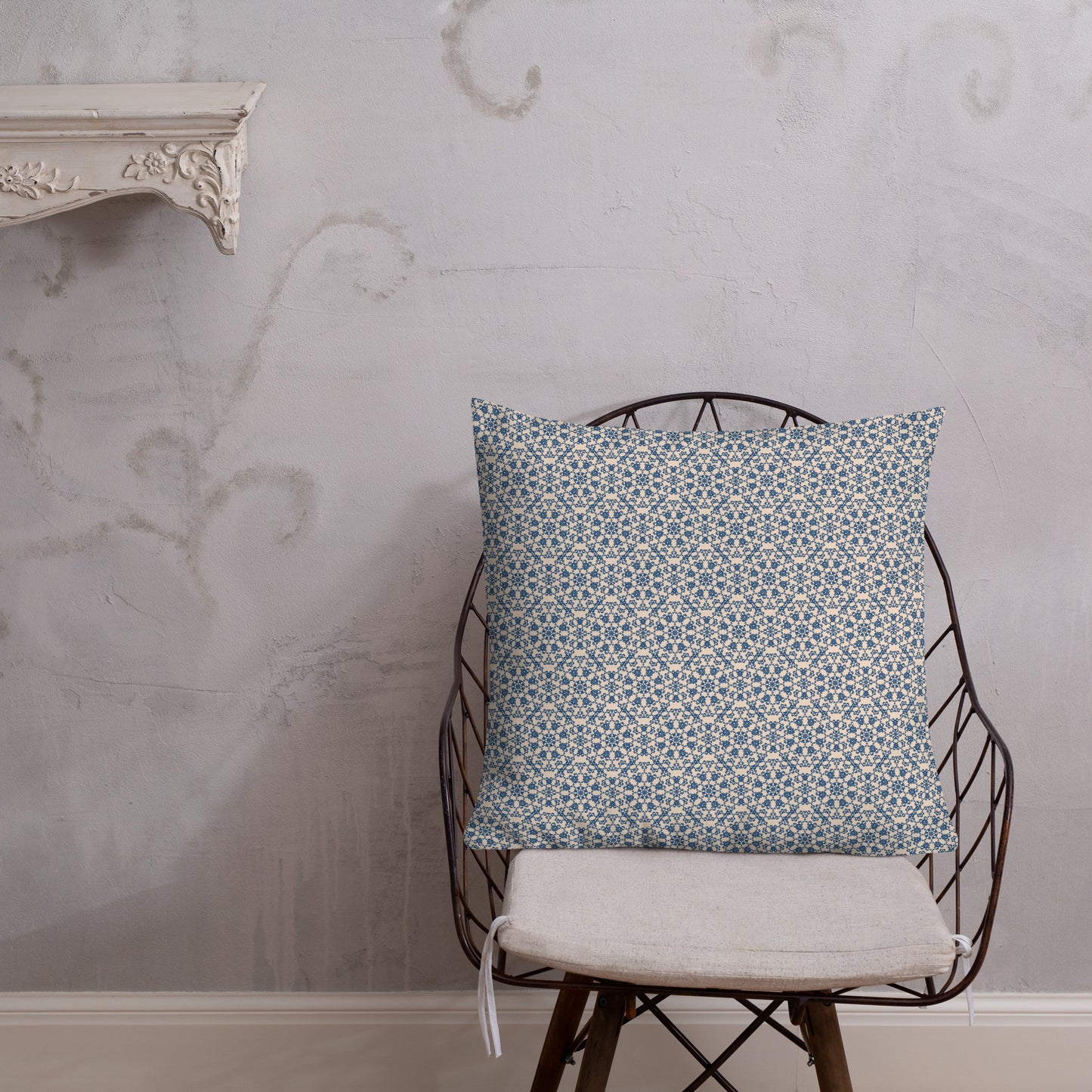 22″×22″ premium throw pillow with the ‘Octagon’ navy and beige geometric pattern on a wire chair.