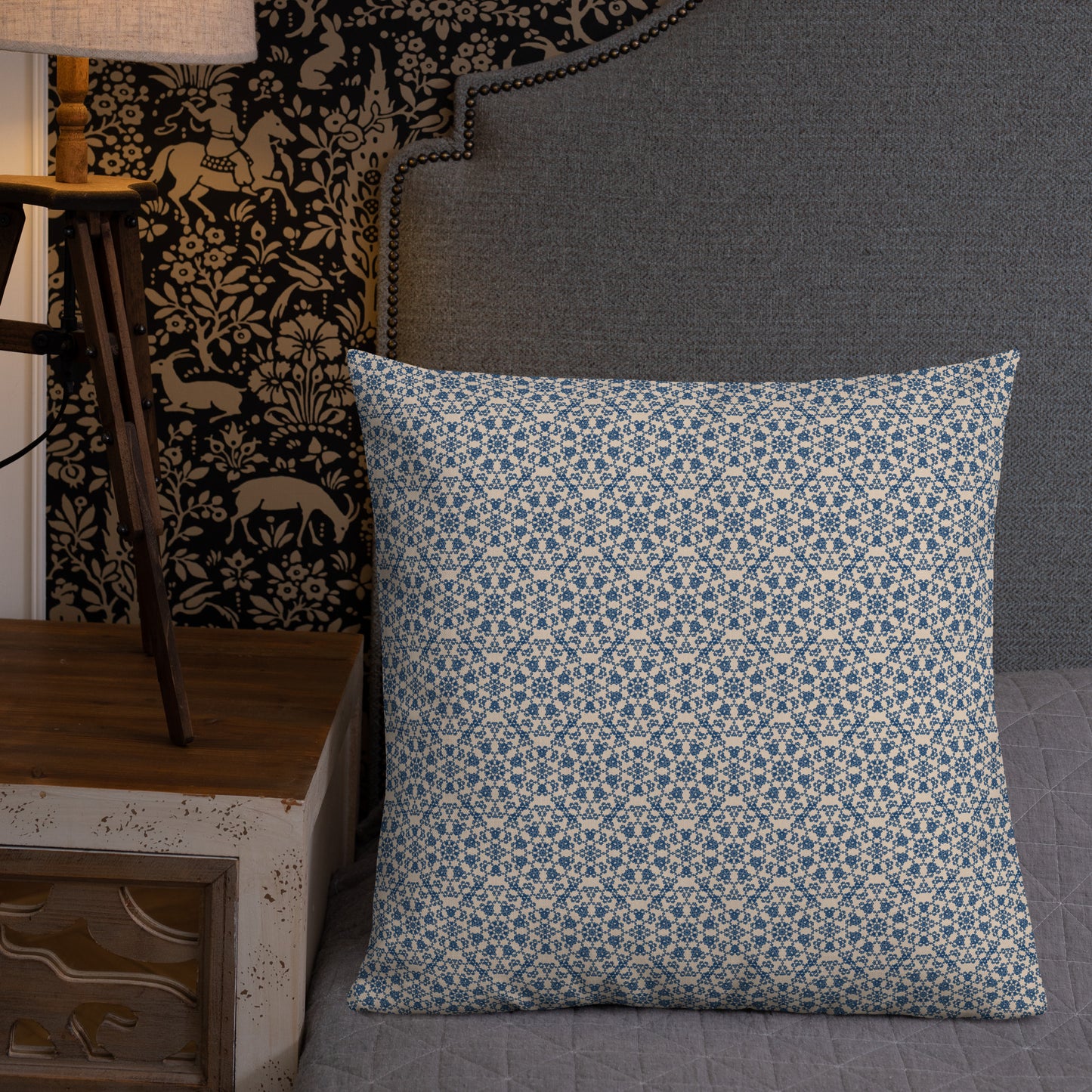 22″×22″ premium throw pillow with the ‘Octagon’ navy and beige geometric pattern on a bed with upholstered headboard.