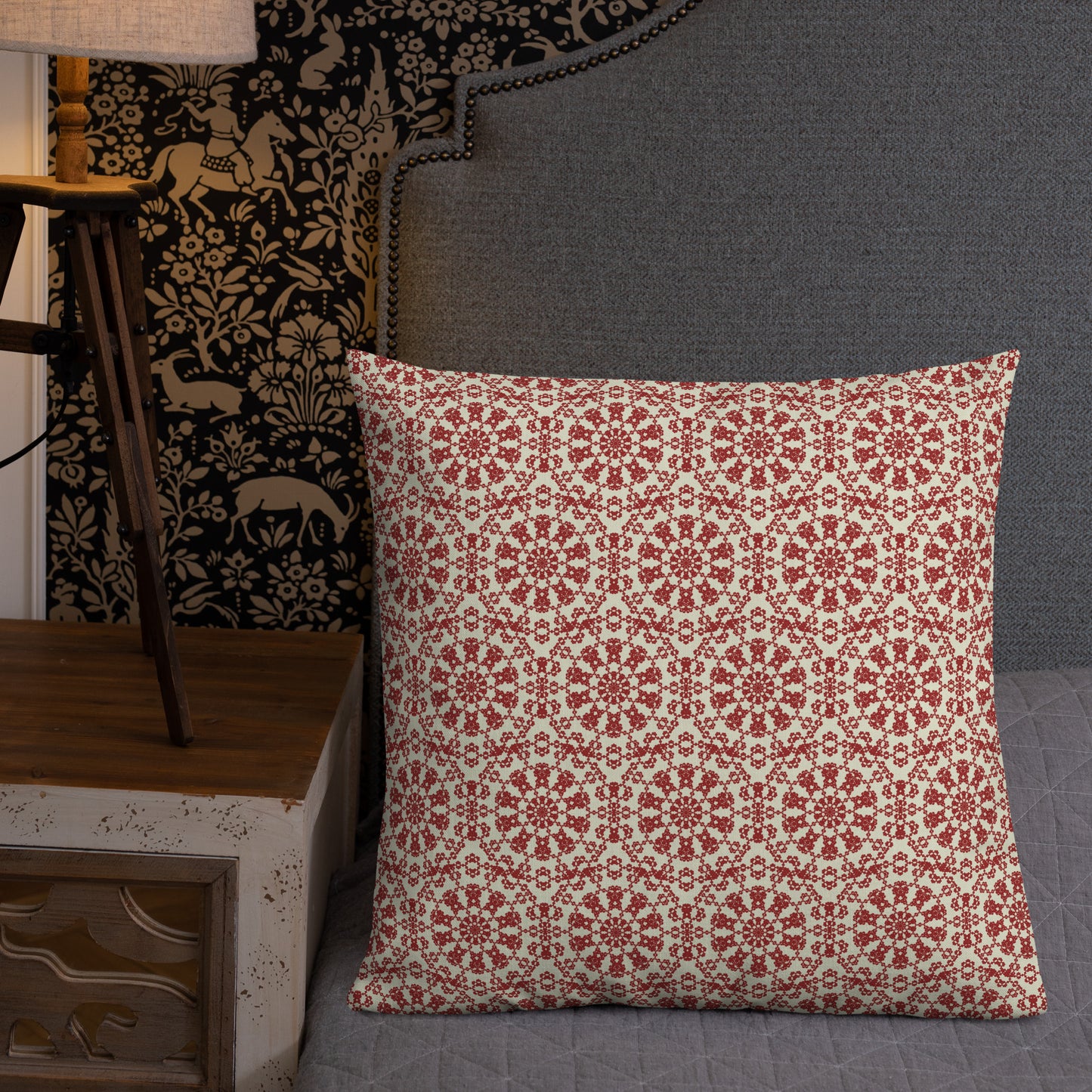 22″×22″ premium throw pillow with the ‘Decagon’ terracotta and beige geometric pattern on a grey bed with an ornate headboard.