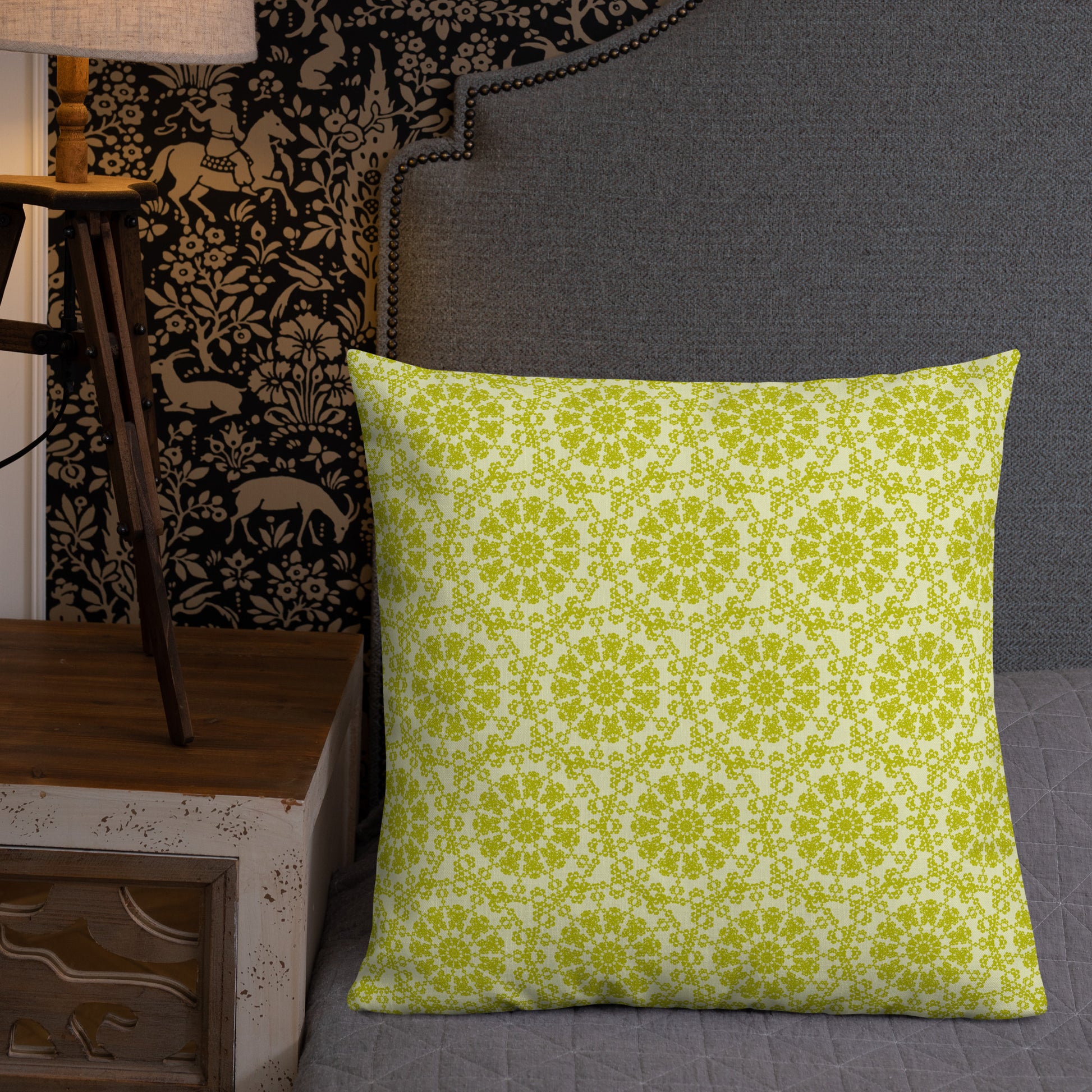 22″×22″ premium throw pillow with the 'Hendecagon' yellow-green geometric pattern on a bed with ornate dark headboard