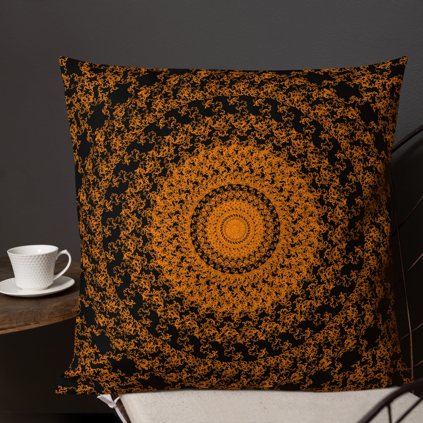 22″×22″ premium throw pillow with the 'The Sun' orange and black geometric design shown in a lifestyle setting.