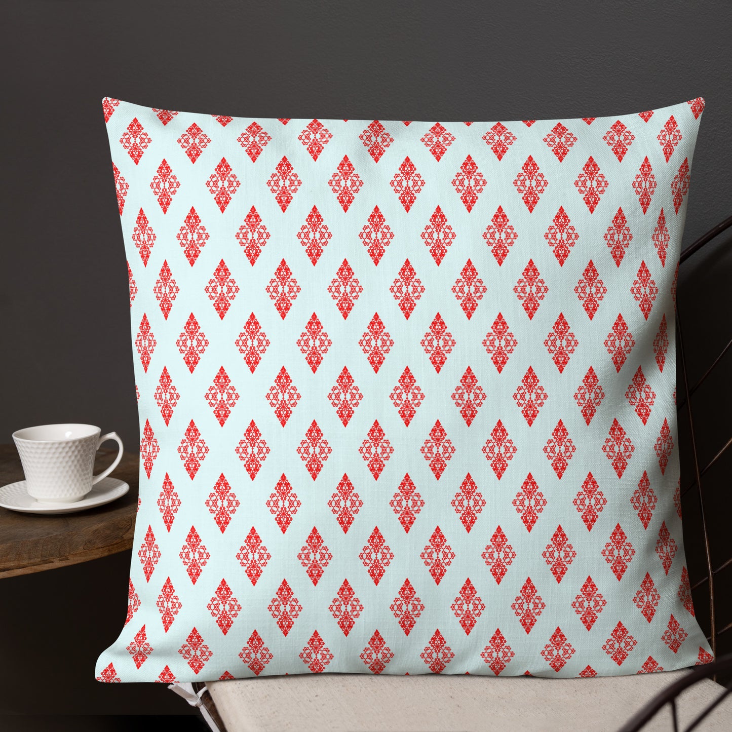 22″×22″ premium throw pillow with the 'Digon' sky blue and red geometric pattern shown in a lifestyle setting.