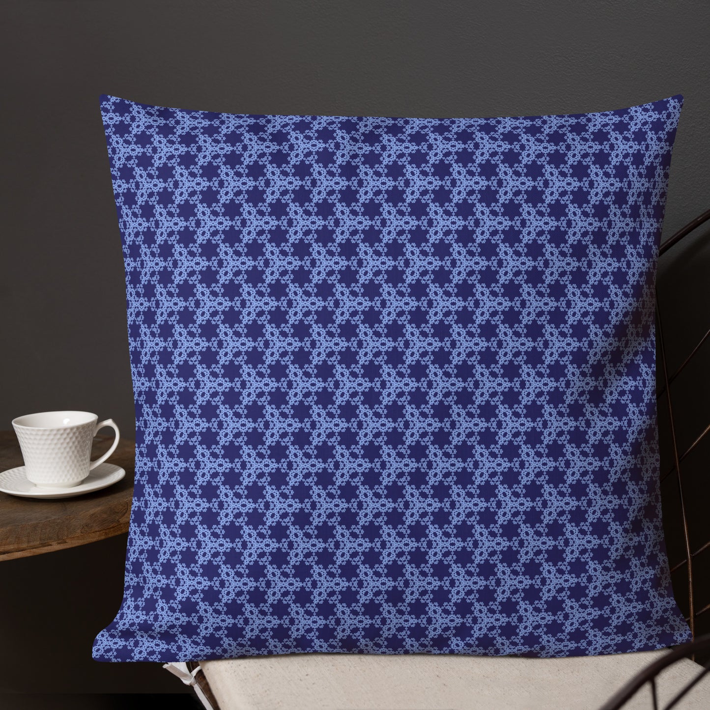 22″×22″ premium throw pillow with the 'Trigon' navy and blue geometric pattern shown in a lifestyle setting.