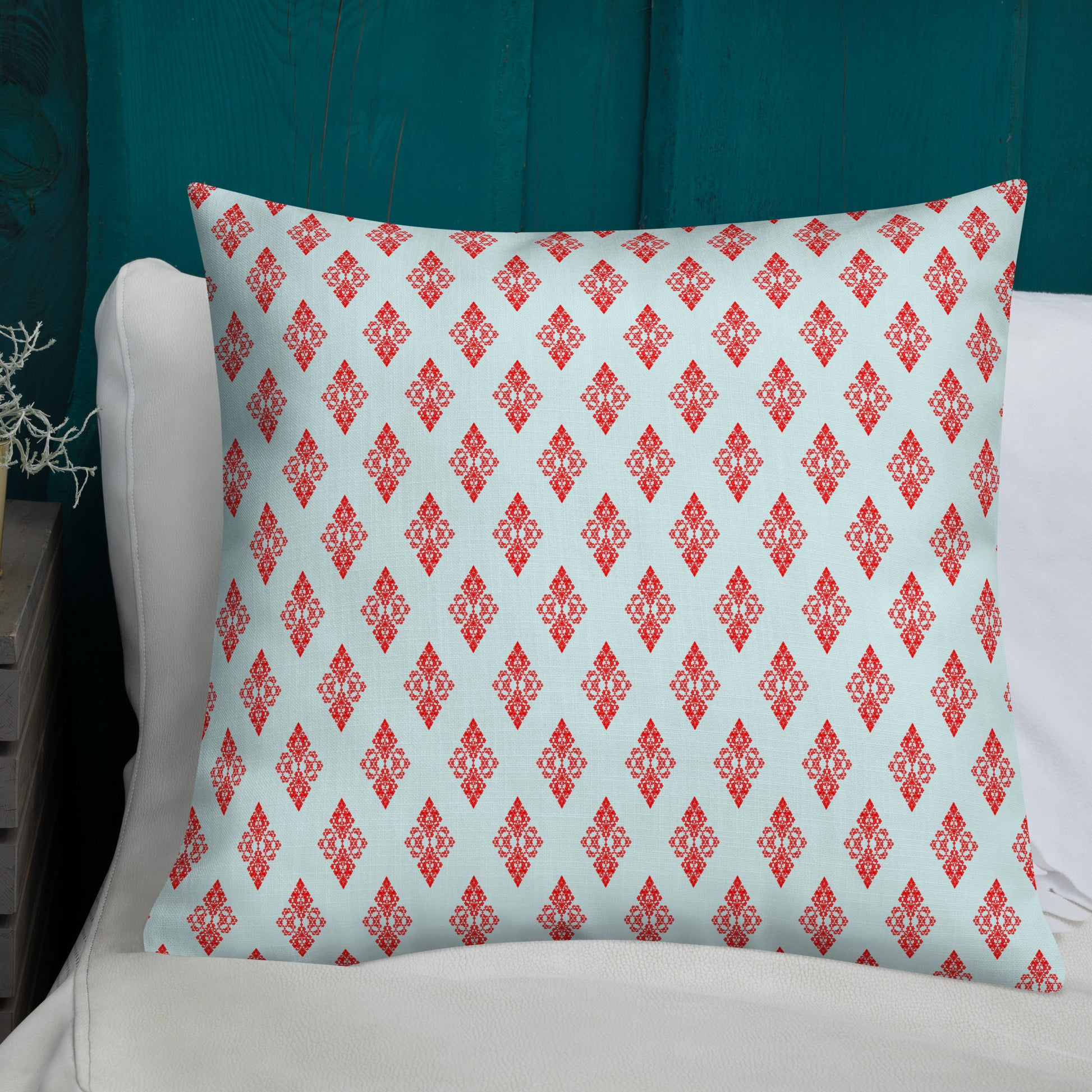 22″×22″ premium throw pillow with the 'Digon' sky blue and red geometric pattern shown in a lifestyle setting.