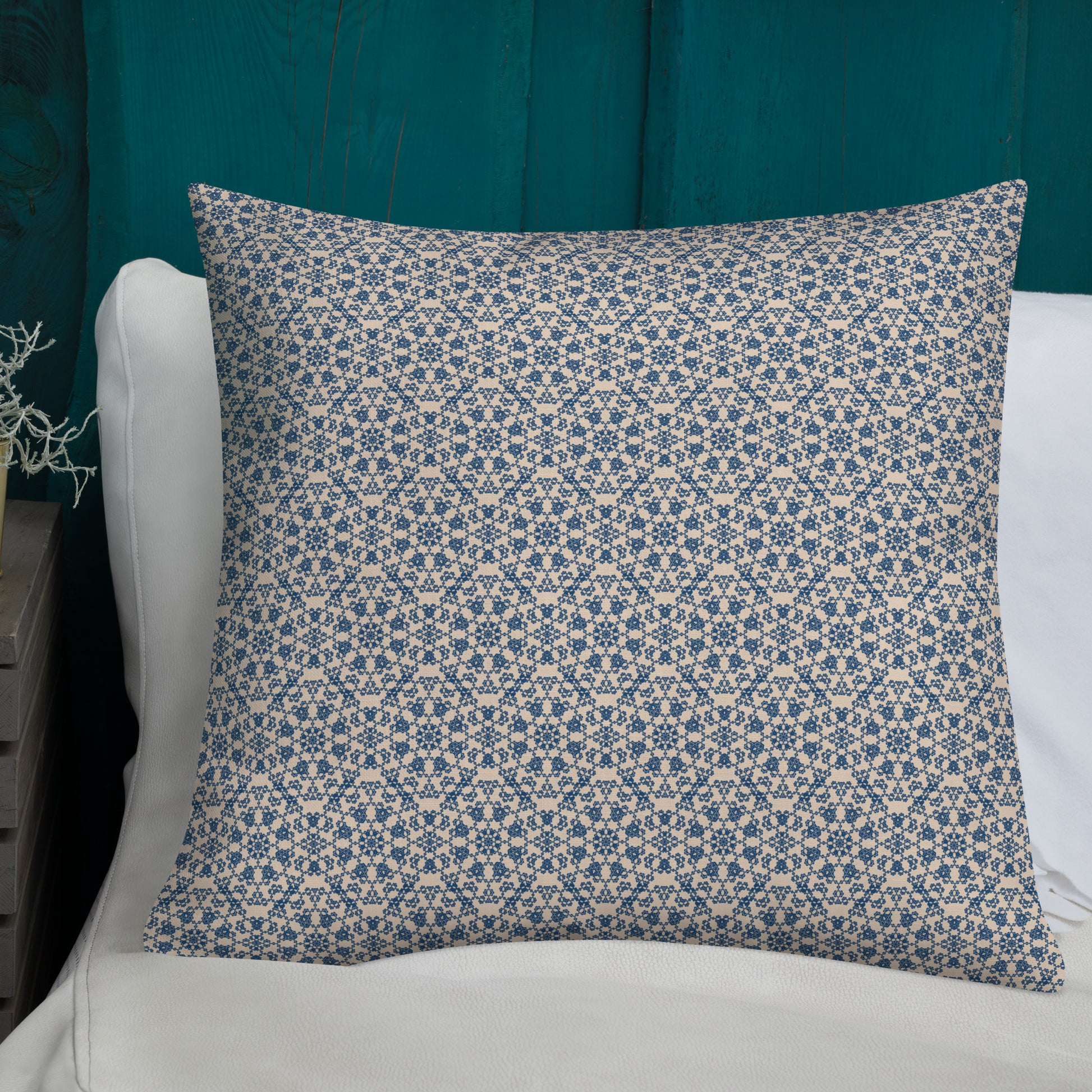 22″×22″ premium throw pillow with the ‘Octagon’ navy and beige geometric pattern on a white sofa with teal wooden wall.