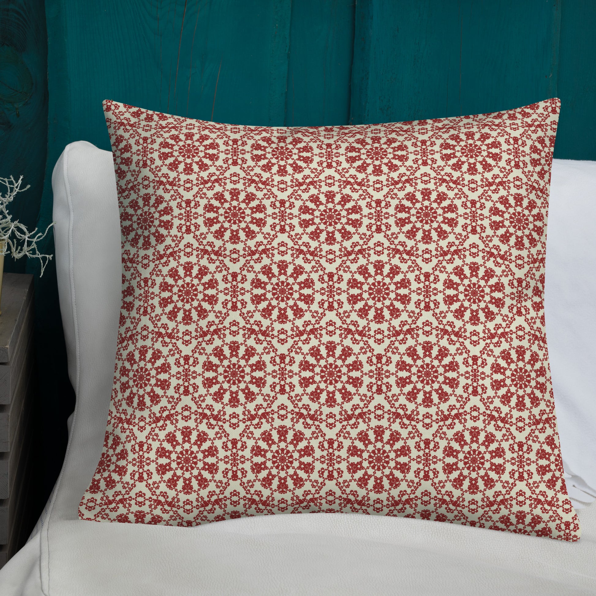 22″×22″ premium throw pillow with the ‘Decagon’ terracotta and beige geometric pattern on a white bed with a teal wooden headboard.